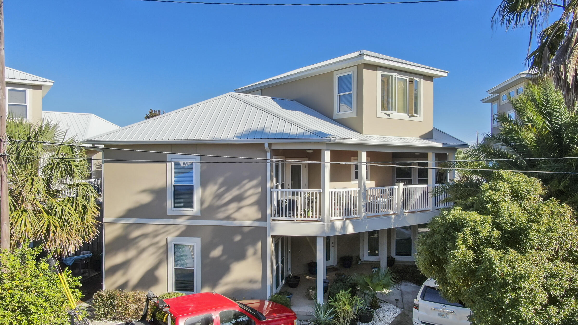 This gorgeous 3 bedroom, 3 bath, 3 STORY BEACH HOME is  just steps to the sand.. public beach access #89 --The location is also just MINUTES TO THE SHOPS AND RESTAURANTS OF 30A! The first floor of the home has a split bedroom floor plan with private en suite bathrooms and PRIVATE ENTRANCES for each bedroom! Both first floor bedrooms are VERY spacious with lots of natural light, walk in closets and doors separating the rooms from the center foyer leading to the second floor. You would have the option of using the home as a primary residence, a vacation home, or a rental or ALL THREE if you wanted to generate rental revenue while occupying the 2nd & 3rd floors of this home! The kitchen on the second floor showcases stainless appliances, granite tops, and plenty of cabinet space. The large living/dining room has plenty of space for entertaining! Fully furnished with tasteful decorations, this home is MOVE IN READY! The large covered balcony has entry doors off the living/dining room and the master bedroom. This oversized balcony is a wonderful place to sit back, relax and enjoy the Gulf breeze! The master bedroom is VERY spacious with lots of natural light, a walk in closet, a beautiful master bath and a door leading out to the balcony. Going up to the third floor there is a fantastic bonus room with beautiful VIEWS OF THE SHIMMERING EMERALD BEACHES! This room would make a great sitting/reading room, family den, gym, or another bedroom! The home has LOTS OF UPGRADES....The HVAC systems are new. It has a Renai gas instant hot water system. The balcony railing was recently upgraded to vinyl, balcony ceiling upgraded to knotty pine, the kitchen flooring upgraded to ceramic plank, hardwood flooring installed in the living/dining room and on the stairs. The exterior of the home was recently repainted and extra pavers added for additional parking out front. This home is also equipped with an Enco SECURITY SYSTEM, and the lawn and gardens irrigated with Rain Bird sprinkler system. There is a 10X12 shed on concrete pad for storage. Come view this property today!