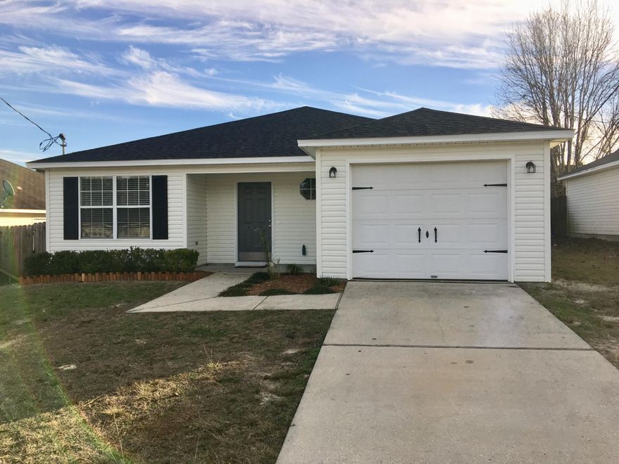 NEW FOR YOU!! Renovated and Updated just for You! Brand new roof, floors, ceiling fans and Stainless Steel Appliances. Freshly painted interior. Beautiful laminate wood flooring throughout and new tile in all wet areas. This is a charming home with a big, open kitchen and living area, 3 split bedrooms, an indoor laundry room, freshly painted garage, Low maintenance vinyl siding, easy care yard, freshly landscaped and pressure washed exterior. All rooms are great in size and the master bath has a huge walk in closet, plus a separate linen closet. Great counter space and lots of cabinets in the kitchen! Seller will provide a 1 year home warranty and assist with some buyers closing cost. See supplemental remarks for more...