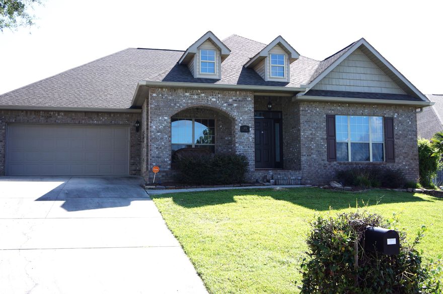 WOW!!! Beautiful, move-in ready home with over 3,000 sqft. of living space for only $95.47 a sq.ft. This fantastic all brick 5 bedroom 3 bath home is located south of I-10 in the highly desired subdivision of Rolling Ridge. With so many extras it's like no other and it's obvious as soon as you walk in the front door. There are beautiful Brazilian Cherry Hardwood floors in the expansive foyer, dining room, family room and bonus/media room with upgraded wiring for HDMI. A solid oak custom door was constructed specifically for the archway to the bonus/media room. The large family room has raised trey ceiling, corner fireplace, views of the fabulous back patio/multi-level deck and is open to the breakfast nook and gorgeous kitchen. You'll really enjoy this kitchen, plenty of room for everyone; Lovely granite counters, breakfast bar, center island, and stainless steel appliances (smooth top range with double oven and microwave/convection oven)  A hallway extension off the kitchen leads to a large walk in pantry, laundry room and the formal dining room. The master suite has a private entrance to the back deck and a great master bath with double vanity, jetted garden tub, separate walk in shower, private toilet and a HUGE walk-in closet. This unique floor plan divides the four additional bedrooms into two separate sets of private quarters. The first set of bedrooms and full bath are accessed through an alcove off the foyer. The second set of bedrooms located off the breakfast nook has a full bath with custom made stained glass in the bathroom window. Outside is a wonderful oversized double layer deck with two pergolas and great lighting for night time entertaining.