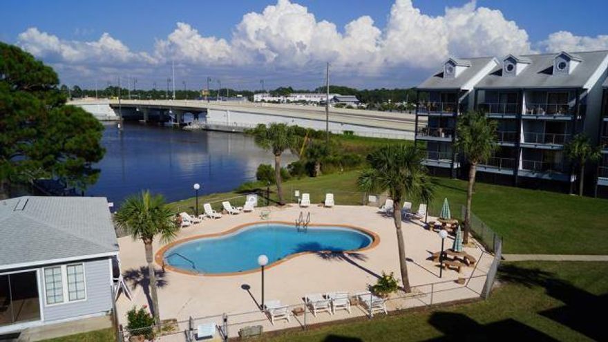 Excellent buy for an updated one bedroom condo on Grand Lagoon in Panama City Beach, Florida with excellent views! Relax and watch the boats go by from your balcony, community pool or community dock. This condo is very close to beach access, boat access and everything you are looking to enjoy on in Panama City Beach. This condo features a good size master bedroom, full bathroom, day bed in the hall and open concept living/kitchen area. You won't find a better price for a condo with this good of a location. This condo is one of the nicer on the property featuring new cabinetry in the kitchen and bath, a new microwave, new hot water heater and is offered fully furnished and decorated.