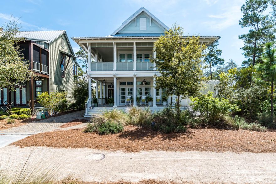 If you have an affinity for the Florida outdoors, you will fall head over heels for this four-story WaterColor Lakefront home with a two car garage and appointed carriage house. This home professionally decorated by Urban Grace Interiors is a MUST SEE! Brick paver pathways transport you to the perfect people watching perch in WaterColor; the homes expansive, wrap around front porch with stately white columns, inviting wood rockers and the glow of the gas lanterns warmly welcome you home. As you enter the home's French front door, you are greeted with white shiplap walls, soaring soft-blue shiplap ceilings, and natural light abound. The open floor plan great room features 7 sets of French doors with transom lighting leading out to the covered porch, a large dining room