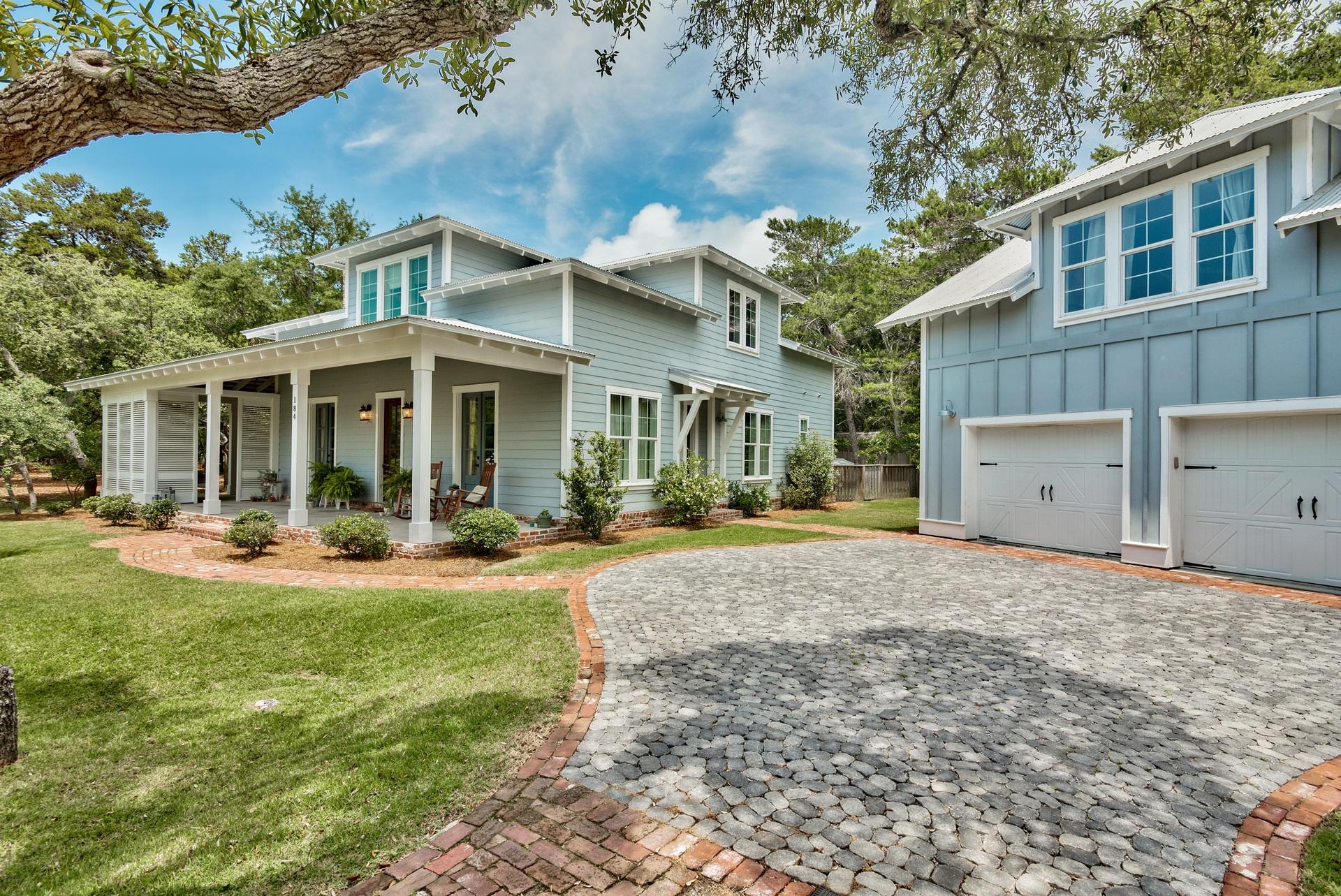 This extraordinary property takes you back to a time and place where there was a true sense of place, the peace and warmth of a real home..relaxing on the front or side porch.visiting with neighbors and friends.walking the dog...strollers and children in the neighborhood.and a peaceful short walk to the sugar sandy white beaches of the Emerald Coast. HOME. This gracefully designed home on a huge lot is a perfect scale with an open floor plan and finishing touches of exposed brick, ship lap, 8 ft solid core doors, hardwood floors, a wood burning fireplace and more. The first floor master suite is a sought after feature along with the fully self sufficient carriage house above a large 2 car garage. This home is ready to welcome a new family. Call today for a private tour.