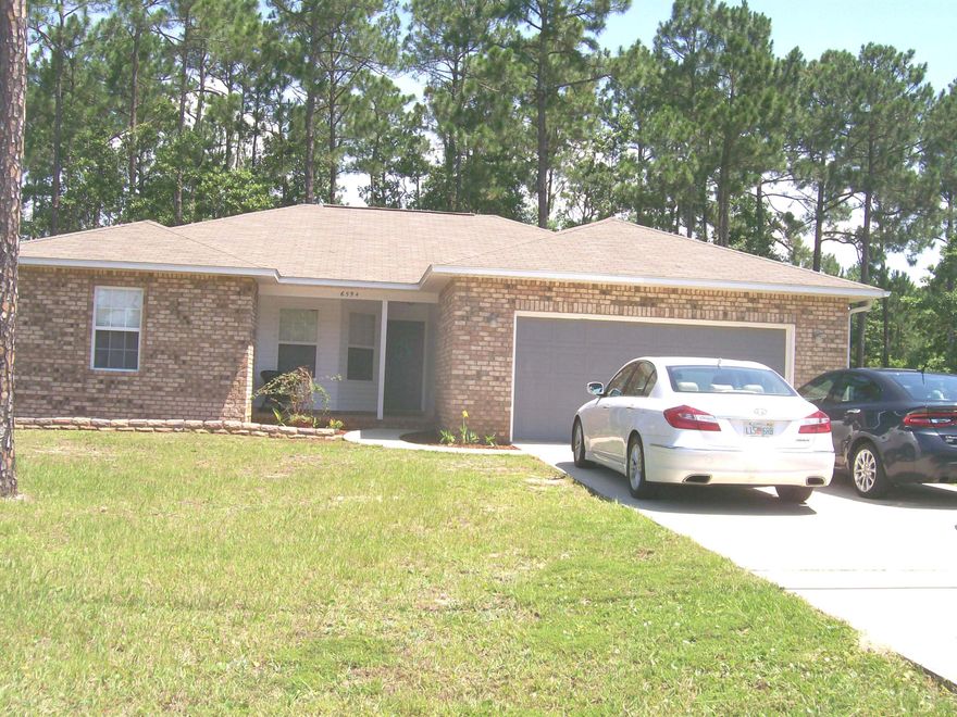 A place to call home! It still has 5 years on the builders warranty. You and your family and guests will enjoy the welcoming covered entry. The spacious living areas are open to the tiled kitchen & breakfast counter. There are custom built oak cabinets and Kenmore appliances. Glass doors give access to the back yard. In the living room, the double-treyed ceiling adds a classy touch. The Master bedroom is on the east side of the house w/double vanities in the master bath. The second bedroom is down the hall, the third one is near the dining area. The builder put architectural shingles on the roof. The Holley By The Sea Recreation Center where you can meet your neighbors, swim, workout, play tennis or just relax is not far away. Call today for your private showing.