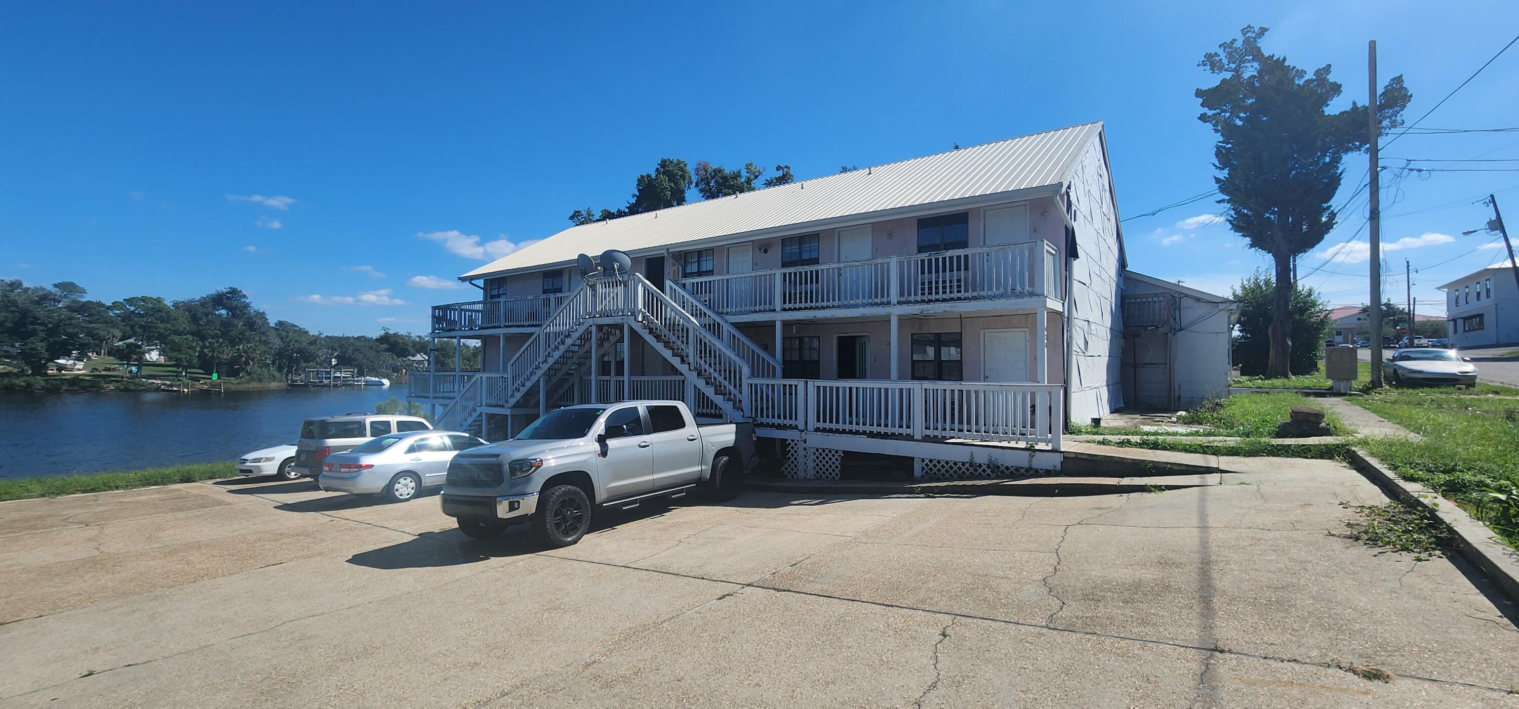 Here's an opportunity to own a multi family property downtown on Massalina Bayou. AS IS. The property includes an 11 unit apartment building with 9 1 Bedroom/1 Bath units, a studio and a 2 bedroom unit. There was storm damage from Hurricane Michael on the west facing wall in which the 2 west units are down to the studs. Property also includes a 2/1 Single family residence on property which is just under 1200 sq feet. Roof was replaced in 2019. Price reflects the need for renovation and rehabilitation on the buildings. Currently 3 of the units are rented. Zoned Downtown District.