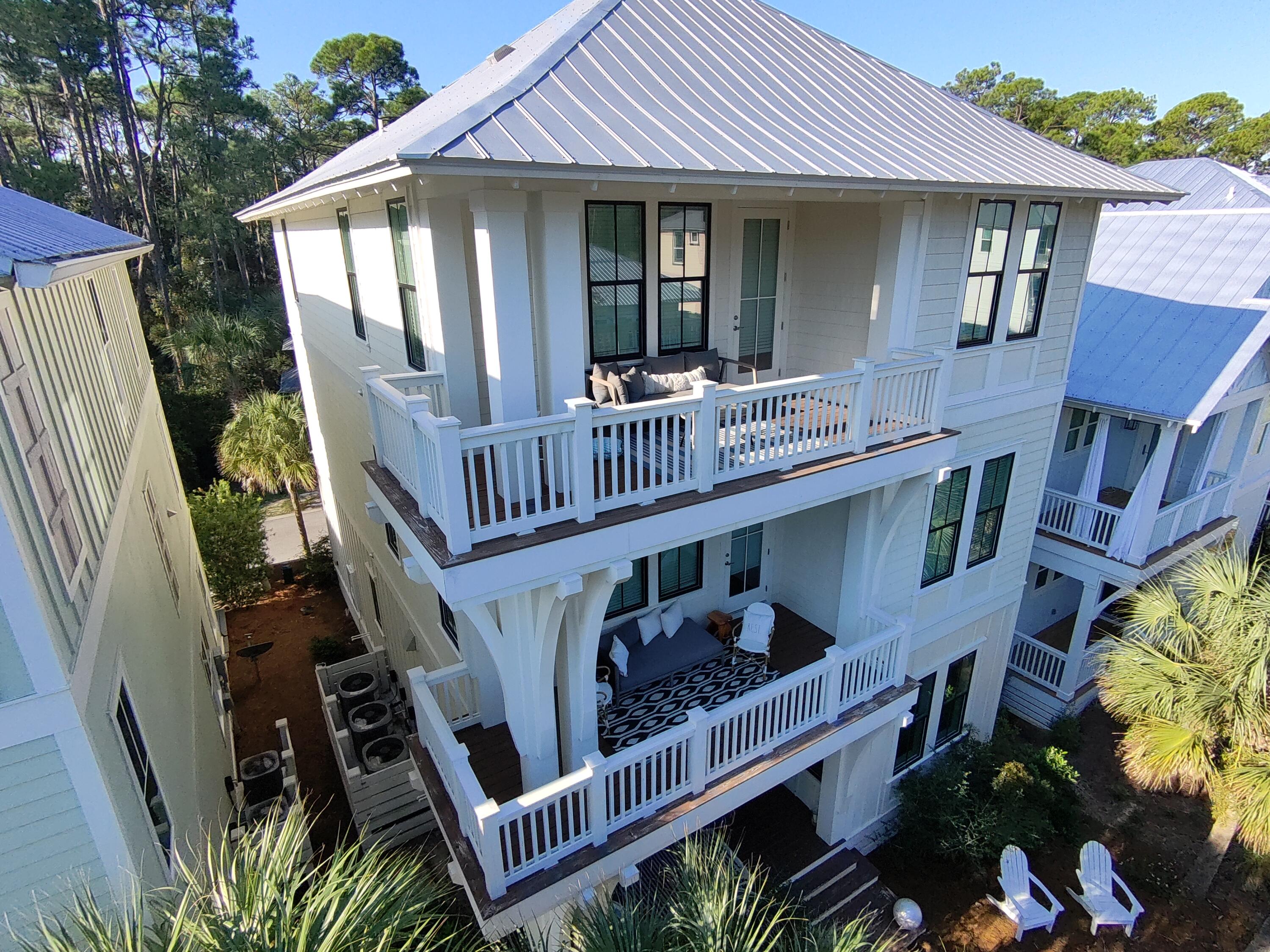 This stunning home boasts an unbeatable location just moments from the beach, nestled in the serene neighborhood of Treetop. Featuring top-notch coastal design and exquisite details, this five-bedroom, five-and-a-half-bath residence offers gated access to the Seacrest beach area and easy access to Highway 98. With its impressive three-story layout, the home includes a spacious open floor plan highlighted by dual master suites with soaring ceilings, a chef's kitchen perfect for hosting, and elegant coastal-inspired hardwood floors. The current owner has added top-of-the-line furnishings throughout, enhancing the home's appeal and comfort. The beach tram stop is just two doors down, providing convenient seasonal shuttle service to your deeded beach