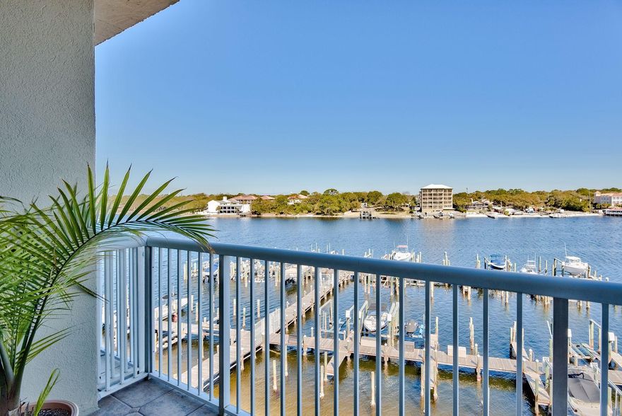 The serenity of water views from your living room and balcony with boats plying their way smoothly through the Intracoastal Waterway is unparalleled. This two-bedroom, two-bathroom condo on the fifth floor of a gated complex beckons boaters, veterans, retired folks, active professionals and investors to its waterfront location. All appliances including the washer, dryer and a 65'' mounted television convey to new owners. The community offers a swimming pool, hot tub and boat dock plus the special benefit of a 25' boat slip and lift rated for 10,000 pounds. Bird life is abundant, and harmony reigns in and around this comfortable waterfront residence. Watch the fireworks at The Landing downtown, take in the sights of the Billy Bowlegs Festival or join the caravan of boats making the trip to Pensacola to watch the Blue Angels fly. You can even catch glimpses of the Gulf of Mexico from the front door of this unit. The sugary white sand public beach access is due South and only 1300 feet away. Home is a primary residence, and the rental projection is $35,000.