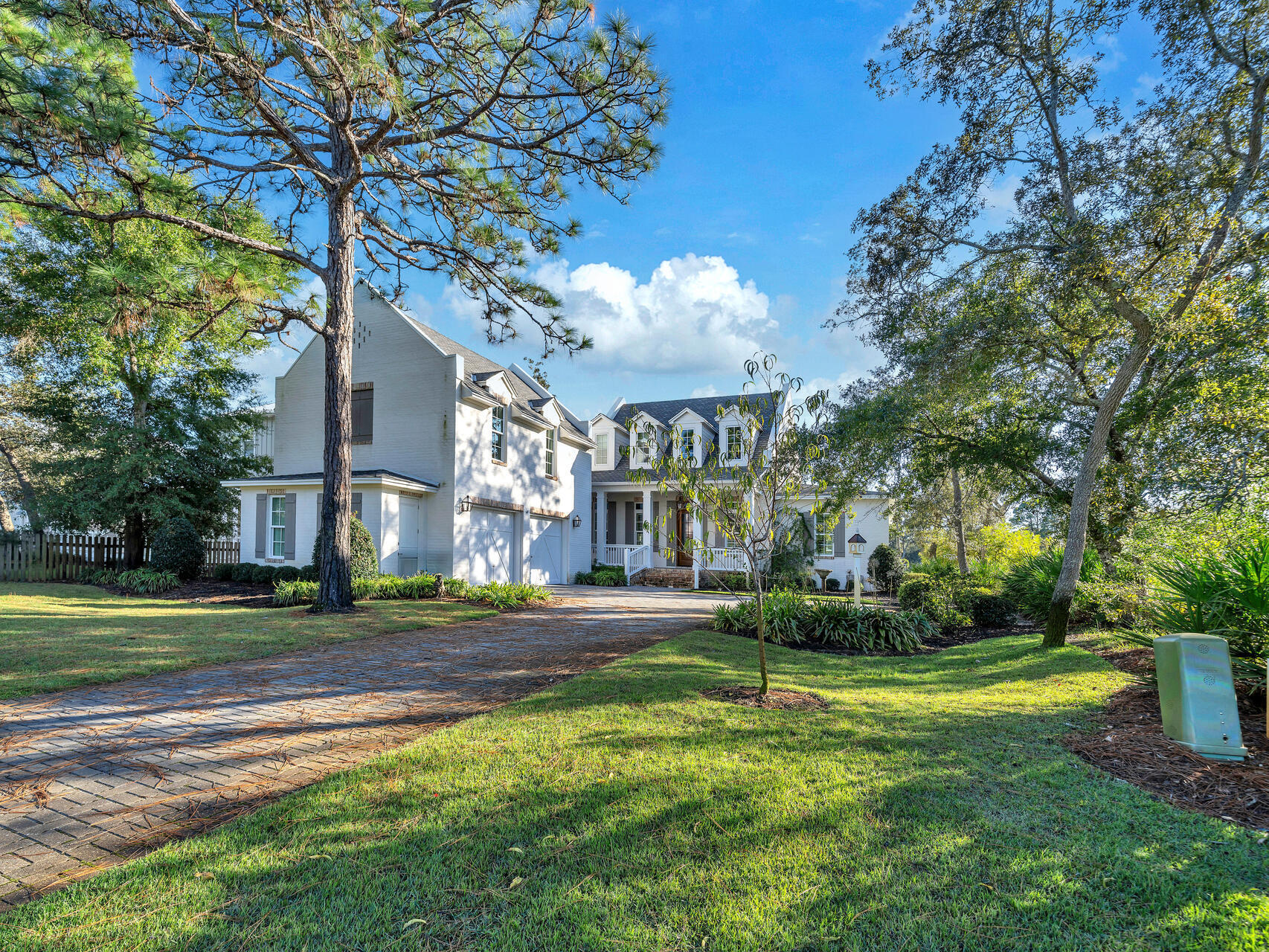 Imagine beginning each day in this stunning, custom-built estate situated on picturesque Buck Bayou, boasting 78 feet of pristine waterfrontage.  This 2020 architectural masterpiece features three bedrooms and four and-a-half bathrooms.  The finished space above the garage, including a half bath, would make an ideal mother-in-law suite or could be easily converted into a fourth bedroom.  Upon entering the gas lantern-lit front porch, one is enveloped in a sanctuary of refined living, complete with three fireplaces, including two indoor showpieces and an outdoor haven.  The gourmet kitchen is a culinary paradise, featuring double ovens, an oversized refrigerator, and exquisite brick detailing.  Hardwood floors throughout exude timeless elegance, while the detached garage offers endless possibilities.  Outdoor living features of this home include a summer kitchen and fireplace along with gorgeous water views.  With deep water access and a meticulously constructed boat dock, lift, and covered boat slip, this property embodies the essence of luxurious waterfront living.  Additional features include automatic remote-controlled shades and screen, ensuring seamless comfort and convenience.  