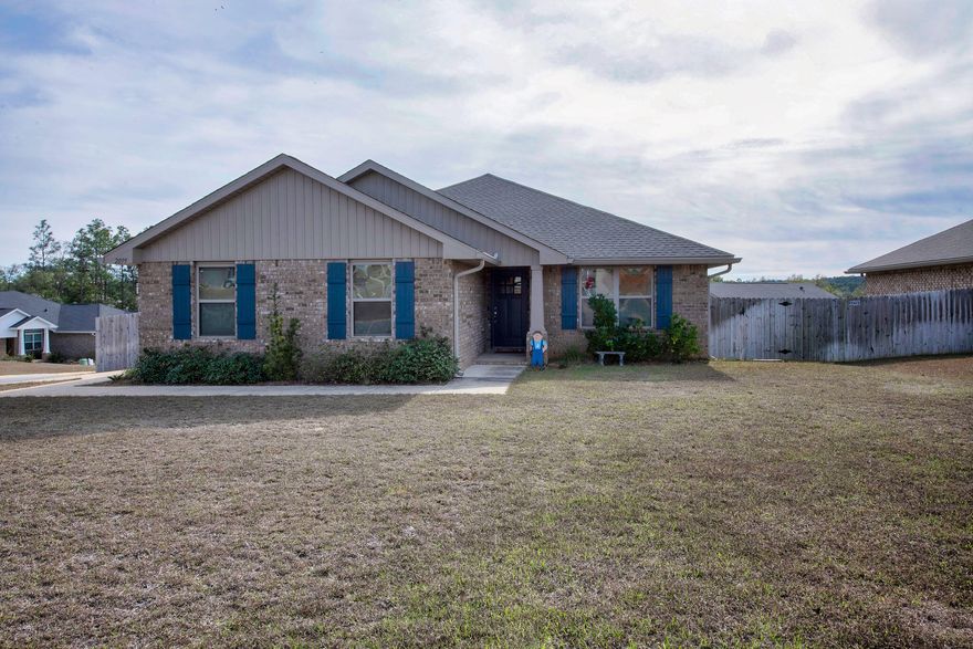 Beautiful, like new 2022 Craftsman brick home on a large corner lot with tons of upgrades! As you step inside this immaculate home, you will be greeted by a spacious open concept Great room with Vaulted ceilings, elegant columns and lots of natural light. The kitchen overlooks the living area and features a large island, granite counters, a pantry and upgraded stainless appliances including a super cool fridge! The split floor plan offers two guest bedrooms and an absolutely huge primary suite with garden tub, dual vanities, separate shower, WC and large walk-in closet. It also has access to the lovely screened porch overlooking the fully fenced, good sized yard with a sprinkler system. Insurance is under $1000/year and as a bonus, a portable generator with manual switch is included. Other notable mentions include; the 2 car side entry garage, whole home gutters, fabric hurricane shutters,  "My Q" Smart garage door opener, video doorbell, security system, upgraded electrical with surge protector, ceiling fans in every room, custom blinds throughout and a transferable termite bond. This is truly an exceptional home, just waiting to welcome it's new owners.