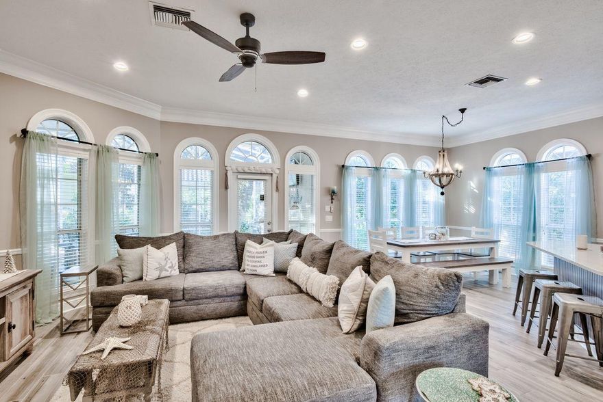 Discover this well-maintained single-story coastal cottage primely located behind the gates of Destiny East. Highlighted by an open floor-plan, this three bedroom residence offers both privacy and serenity with notable features such as a large covered screened porch with ample space for relaxing or entertaining, manicured landscaping, spacious two-car garage as well as recent upgrades including fresh interior paint, new low maintenance porcelain plank flooring throughout and a beautifully remodeled kitchen complete with granite countertops & stainless steel appliances. As you enter the home, you're immediately greeted by the abundant natural lighting and open floor plan that this home offers.