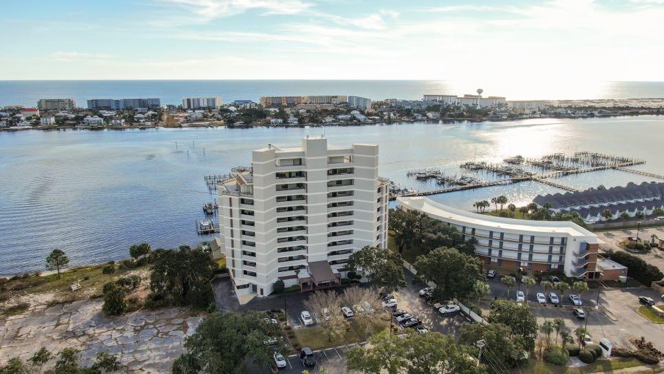 BE PREPARED TO HAVE YOUR BREATH TAKEN AWAY WHEN YOU WALK THROUGH THE FRONT DOOR OF THIS AMAZING WATERFRONT CONDO!! AFTER YOU HAVE ENTERED THROUGH THE SECURE LOBBY. BECAUSE IT IS ABSOLUTELY STUNNING IN EVERY SENSE OF THE WORD. FROM THE GORGEOUS TILE FLOORS, TO THE FABULOUS KITCHEN WHICH WOULD BE THE DREAM OF ANYONE WHO ENJOYS COOKING WHILE ENTERTAINING & VISITING WITH GUESTS SITTING AROUND THE OVERSIZED ISLAND AND STARING OUT AT THE BEAUTIFUL WATERFRONT VIEWS! TWO HUGE BEDROOMS WITH ROOM ENOUGH FOR KING SIZED BEDS AND ANY OTHER FURNITURE YOU DESIRE WITHOUT BEING CROWDED. PARK ANY BOAT IN YOUR 10,OOO LB BOAT LIFT IN YOUR DEEDED BOAT SLIP THEN TAKE AN EVENING SWIM IN THE BEAUTIFUL POOL WHILE WATCHING THE SUNSET OVER THE SANTA ROSA SOUND! CONVENIENT & JUST MINUTES TO ANYWHERE YOU NEED TO BE!