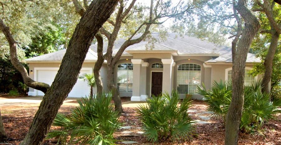 Spacious Destin home located on a cul-de-sac in a quiet subdivision. This house features an open, split floor plan with master set apart from the other three bedrooms. The foyer, dining room, and living area boast 11' ceilings. Upgraded touches such as wood floors in the living room, bead board detail in the guest bathrooms, and custom stone work around the fireplace. The cozy covered back porch looks out to the beautiful oak trees. Washer and dryer included