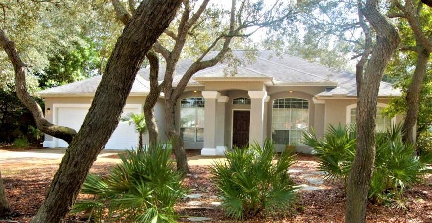 Spacious Destin home located on a cul-de-sac in a quiet subdivision. This house features an open, split floor plan with master set apart from the other three bedrooms. The foyer, dining room, and living area boast 11' ceilings. Upgraded touches such as wood floors in the living room, bead board detail in the guest bathrooms, and custom stone work around the fireplace. The cozy covered back porch looks out to the beautiful oak trees. Washer and dryer included