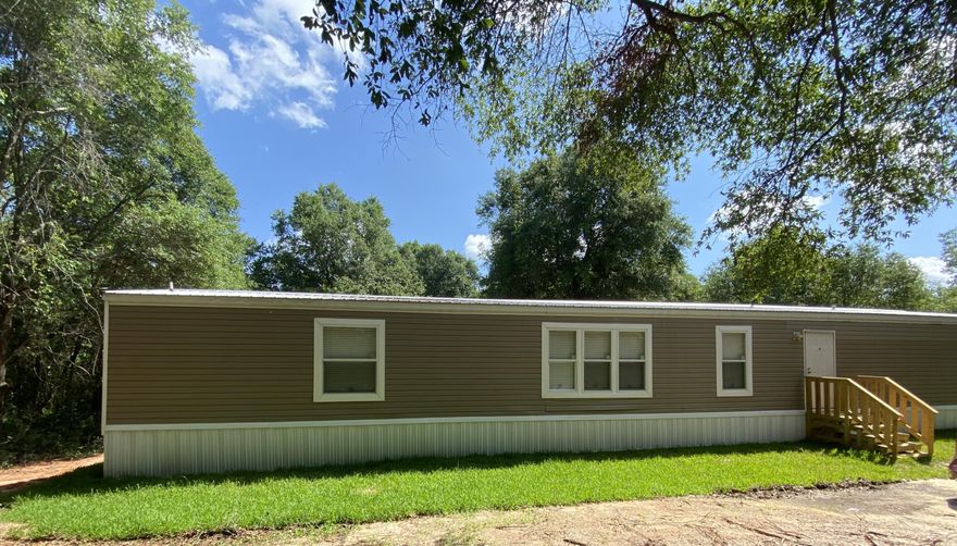 Very nice 3 bedroom 2 bath mobile home situated in the center of a wooded lot for your privacy.  Large kitchen area with an island sink and breakfast bar, pantry located by the refrigerator, and a small area for your table.  Very nice front load washer and dryer for your convenience.  The large suite is big enough for a king bed.  The bath comes complete with double vanity, walk in closet, large tub, and separate shower area.  This is a split bedroom plan with a nice sized second bedroom.  Hurry and call today to see this jewel.