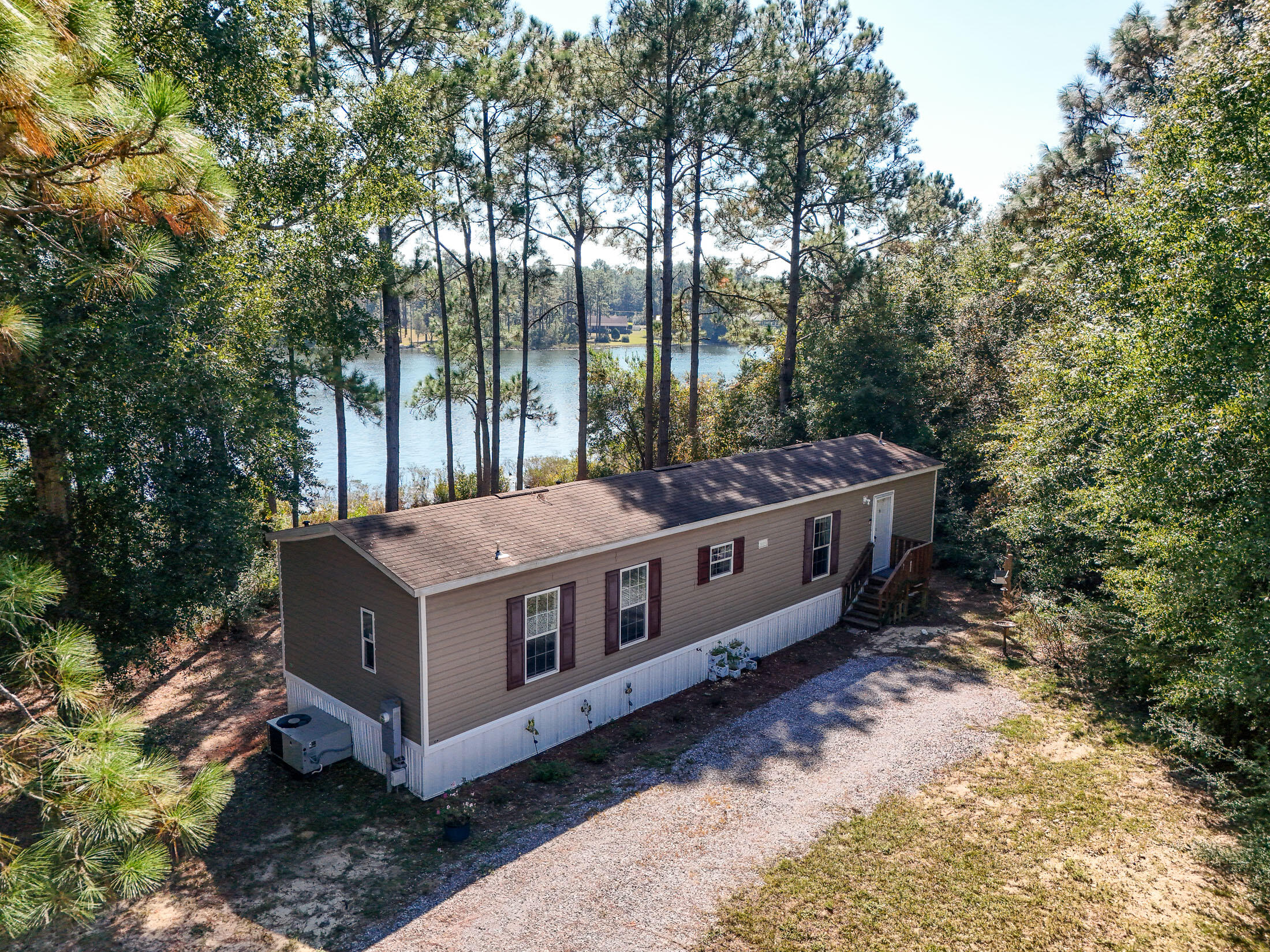 This charming 2-bed/2-bath home is nestled on a serene 1/3 acre waterfront lot, offering a peaceful retreat with stunning views of Imperial Lake. Would make an ideal first home, retirement home or an affordable snowbird hideaway. Lots of wildlife from fish to turtles to eagles in this quiet location. The property is in excellent, like new condition, featuring a deck perfect for relaxing and enjoying your morning coffee. Enjoy the convenience of an RV hookup as well, perfect for both you or traveling guests coming to see you in Florida. Located just 30 minutes north of the white sandy beaches, and less than 10 minutes to downtown DeFuniak Springs with boutique shopping, restaurants, and the big box stores we depend upon. It's rare to find a clean, excellent condition home at this price!