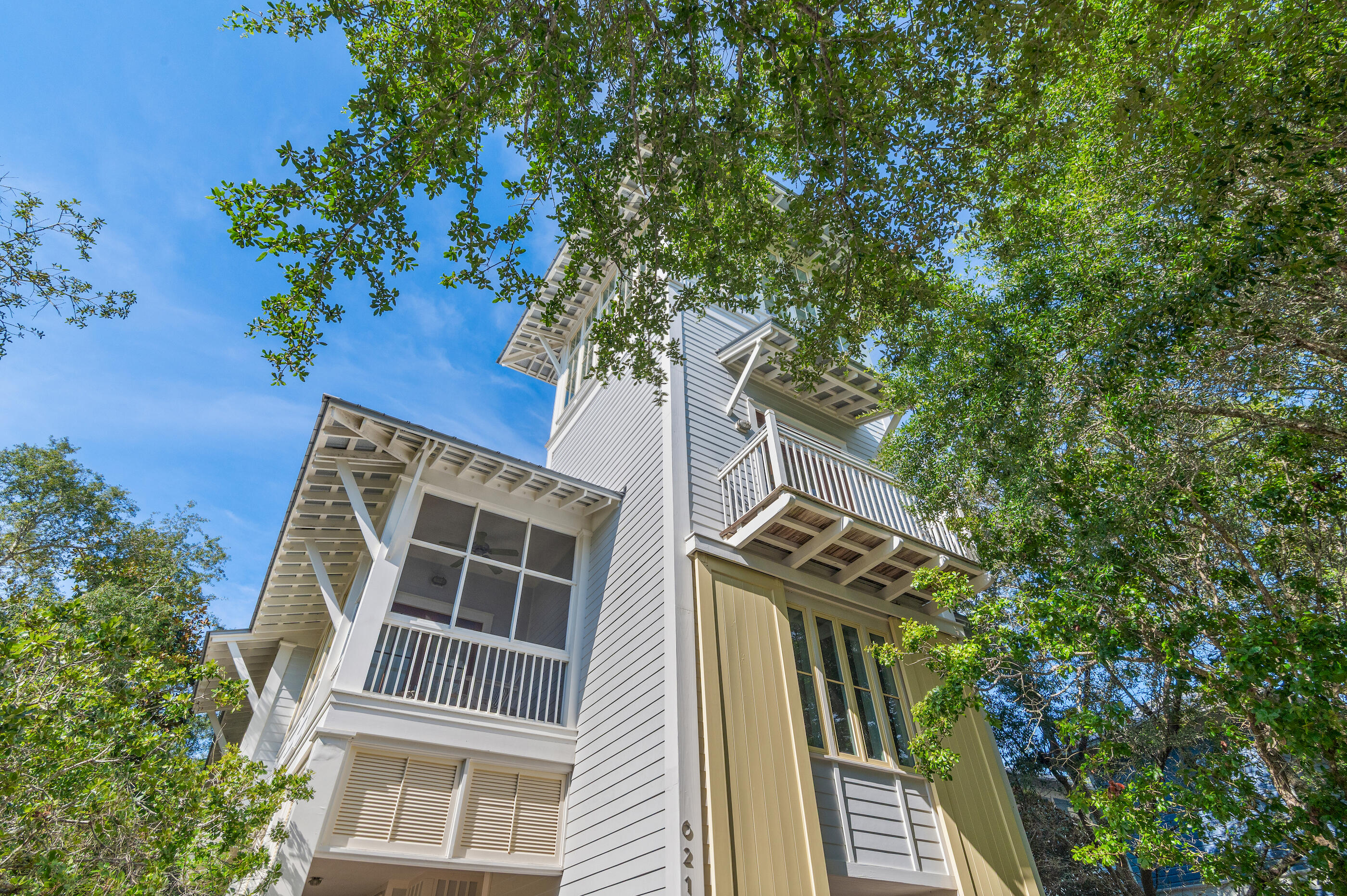 Located on Western Lake in coveted WaterColor Phase I, this architecturally stunning custom home offers rare Gulf and lake views from one of the tallest towers in the community--complete with wet bar and lounge. Just steps from the Boat House, Amphitheater, and a short walk or ride to the Beach Club, the home features a vaulted second-floor living space with wood ceilings and walls of windows, opening to a screened porch with fireplace. Highlights include Sub-Zero, honed marble, antique heart pine floors, and custom cabinetry. With 5 bedrooms, private office, multiple porches, and room for a pool, this elegant, light-filled home is perfect as a primary, second, or rental property.