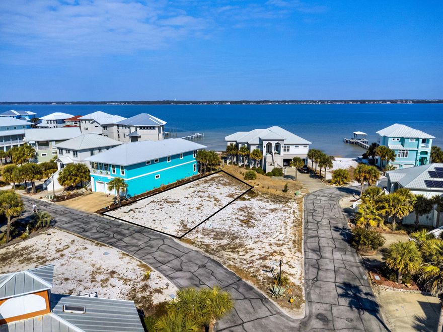 Discover an exceptional opportunity to own a premier homesite in Caribbean Isle, one of Navarre's most sought-after gated communities. This beautiful lot provides the ideal setting to design and build your custom residence, perfectly positioned to capture views of the tranquil Santa Rosa Sound.Imagine starting each day with peaceful water views and ending it with breathtaking Florida sunsets painting the sky over the Sound, a stunning natural backdrop for your future home.Residents of Caribbean Isle enjoy the privacy and security of a gated entrance with controlled access, along with amenities designed for both relaxation and recreation. Community features include tennis courts, pickleball courts, and a sparkling community pool, perfect for unwinding after a day at the beach or enjoying  time on the water.

Whether you envision a primary residence, a vacation getaway, or an investment opportunity, this homesite offers a rare and desirable canvas to bring your vision to life. Don't miss your chance to own a piece of Navarre paradise, complete with sound views, gated living, and outstanding community amenities.