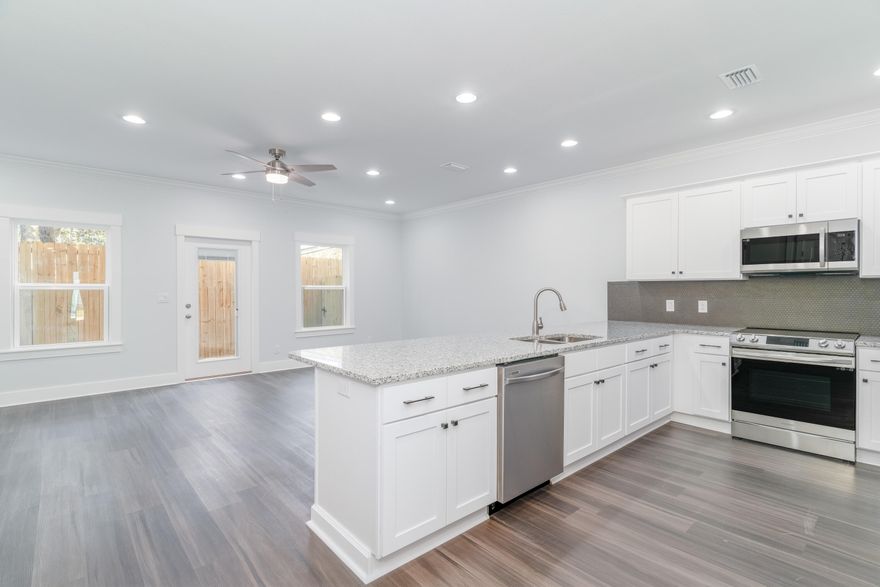 New Construction & Ready to Move In! Builder is giving $10,000 ANYWAY MONEY which makes this a $0 move in if used towards closing costs! Use this money towards an Interest Rate Buy Down, closing costs, and/or washer & dryer!  Luxury Vinyl Plank throughout entire unit. Upstairs is all bedrooms, full guest bath, on-suite bath for primary & laundry room. Downstairs hallway leads to ½ bath, kitchen w/ breakfast peninsula & Upgraded Stainless Appliances such as side by side refrigerator, Self-Cleaning Convection Stove w/ Air Fry, built-in microwave/range hood & dishwasher. Kitchen opens to the living & dining room. Back door leads to privately fenced backyard with a gate on either side. Epoxy Sealed Garage Flooring & Exterior Lights on Automatic Timer