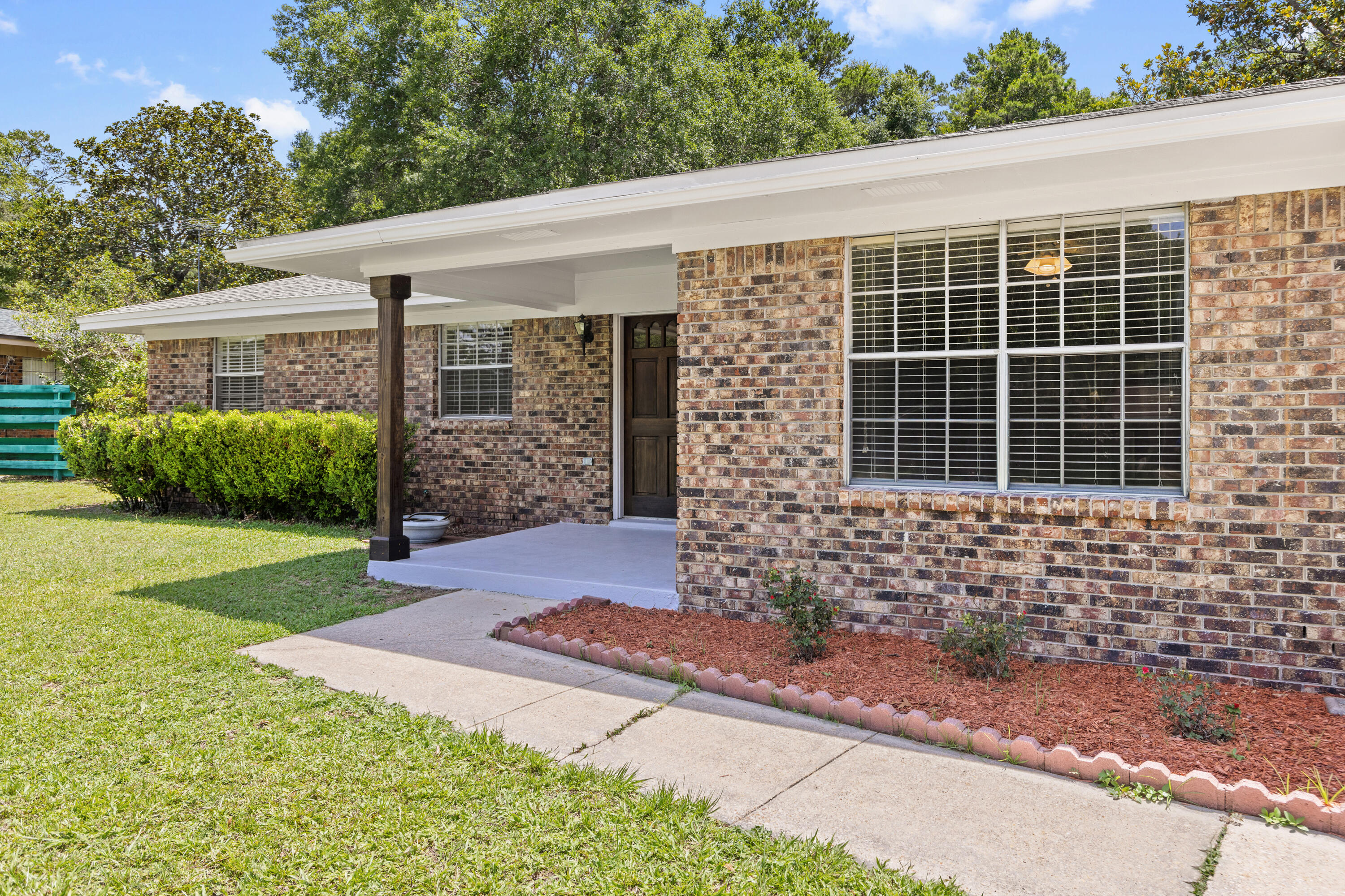 Discover an all-brick Rocky Bayou home that masterfully blends classic construction with contemporary upgrades. Your welcoming journey begins at the solid core wood front door, framed by fresh exterior paint that hints at a lovingly maintained space. Step inside to find a striking kitchen outfitted with brand-new luxury vinyl plank flooring and granite counters with a breakfast bar, perfectly complemented by a Whirlpool suite of quality appliances and maple cabinets. Adjacent to the kitchen is the laundry room where a triple-cabinet pantry provides extra storage for canned goods, snacks, and kitchen devices, streamlining everyday organization. The home's durability and modern conveniences shine with features like a dimensional shingle roof (installed in March 2021), click ''read more'' a newer electric 40-gallon Rheem water heater (2021), and an HVAC system that was replaced in May 2025. Other recent enhancements include a complete rewire of the house (May 2025), all interior walls and textured ceilings were painted, newer carpeting in the living room and bedrooms (2023), all assuring functionality, comfort, and peace of mind where it matters most. Additional thoughtful touches elevate this home further. All rooms have stylish paddle light switches, the bedroom closets boasts a motion-sensored light fixture, all rooms have 2-inch faux blinds, all doors have the brushed nickel knobs, adding a refined touch throughout. Every detail has been thoughtfully considered! Outside, a 13' x 22' screen porch with vinyl windows offers a relaxing retreat for extended enjoyment of the outdoors, while the large yard and the all-natural "park" area beyond the property line creates a serene backdrop while adding privacy. Tucked in the rear corner is a garden shed for lawn mower and yard tools.The property is located within Niceville's city limits which affords access to our great public library, children's park, pickleball courts and softball complex. Bring your boat, jet skis or kayaks to the Fred Gannon State Park which is just 1.2 miles away. This property offers both conveniences and natural beauty. Note that access to the Rocky Bayou Country Club's pool requires a membership, adding an exclusive recreational benefit to this exceptional residence.This home is a true sanctuary where practical updates meet enduring style. Its careful upgrades and inviting spaces set the stage for a comfortable lifestyle that's both modern and timeless. Are you ready to explore how each crafted detail enhances your living experience?