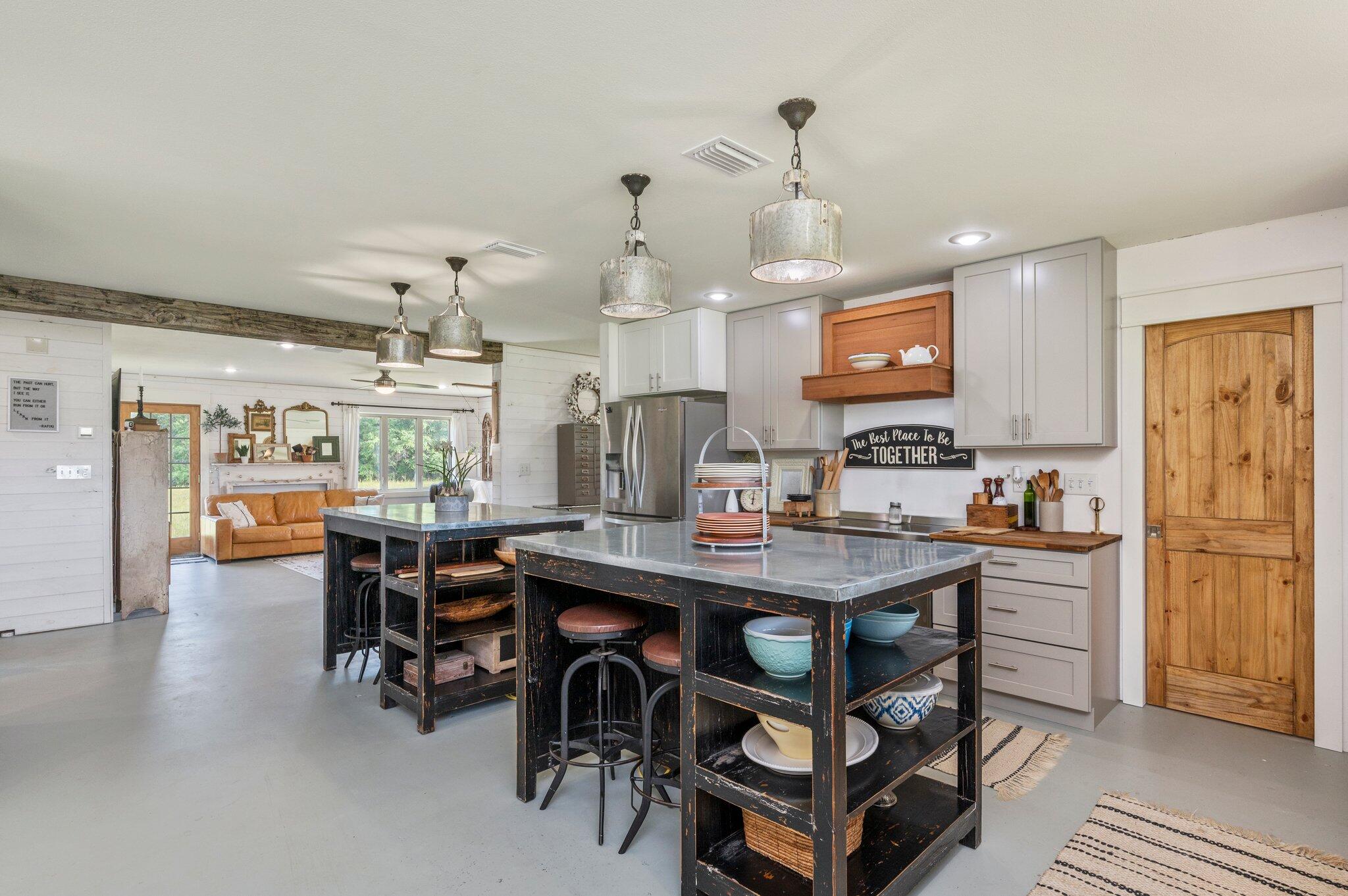 MOTIVATED SELLERS on this 4 BD/3.5 BA beautiful home situated on approximately 6.65 acres. The home features all metal exterior construction w/ a nice front porch for relaxing. Inside you will find shiplap, exposed beams, barn doors and an overall eclectic styling of the home throughout. The open floor plan features a spacious kitchen w/ twin grandiose islands boasting metal tops and bar seating, beautiful cabinetry and adjacent dining area. Living room has lots of shiplap and large pane less windows giving this room a light and airy feel. Craft room (w/ cabinets), master suite w/ full bath (or guest whichever you choose) and half bath are also located downstairs. Upstairs is a second larger Master Suite w/ dual vanities, large tiled
