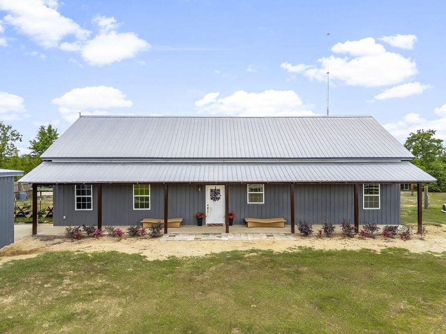 Country Living at its best on 10 Acres with a lovely 3 bed, 3 bath home, a Guest House, 2 Stall Barn & Workshop, all less than 1 mile from beautiful Ecofina Creek & Sylvan-Pitt Springs! Welcome to 7416 E Hwy 20 in Youngstown -- a beautifully maintained country homestead set on 10 partially fenced acres. This private slice of North Florida paradise is perfect for anyone seeking a peaceful rural lifestyle, with the flexibility to bring horses, livestock, ATVs, or big toys. There's space for it all, and then some. Also available is the additional 10 acres next door see MLS #772825 The main home offers a warm, modern charm combined with an inviting open layout. Inside, you're greeted by the grandeur of 26-foot high vaulted ship lapped ceilings.