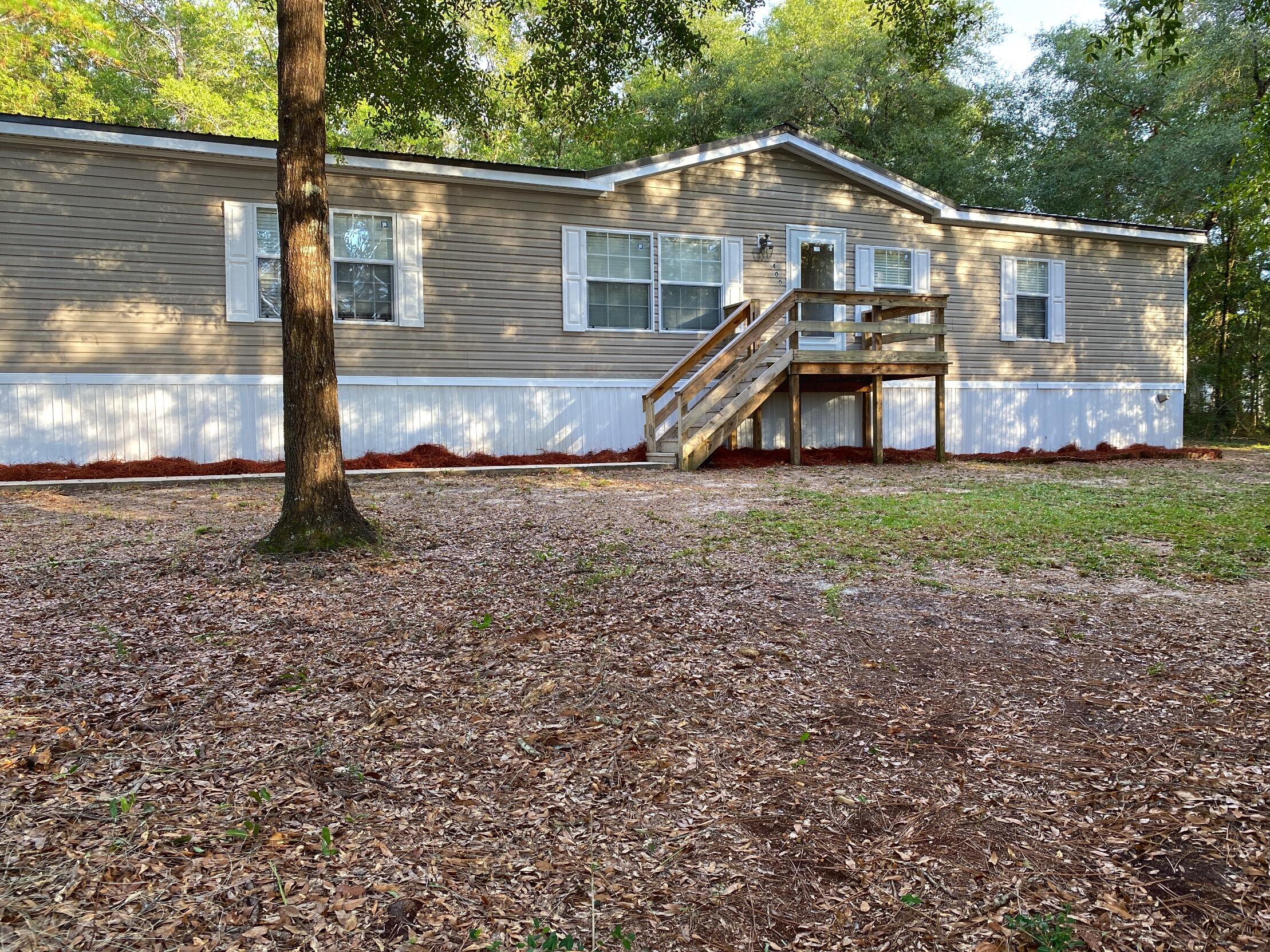 Great Property! Located on 10 spacious acres, great condition and move-in ready 2280 sq ft manufactured home with 4 bedrooms & 2 bathrooms. New metal roof in 2018. The open floor plan makes it easy to navigate with the living room, family room & kitchen being connected by the dining room. The over sized master bedroom with 2 ceiling fans gives you plenty of room to have king sized furniture & a sitting room area. The split bedroom floor plan puts the other three bedrooms, additional bathroom & utility room on the other side of the home. New flooring in kitchen, laundry and hall, closed in workshop and multiple hunting blinds left on the property.