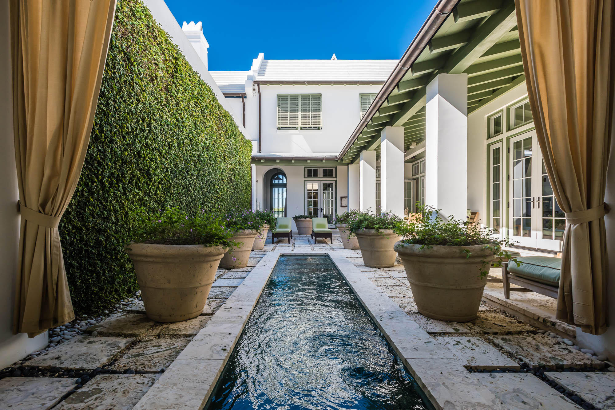 Designed by architect Gary Justiss, this 2,187 square foot whitewashed masonry, courtyard home has 3 bedrooms, 3.5 baths and is located close to Caliza Pool, Amphitheater, Fonville Press and playground. And only a short walk or bike ride to the private beach and Owners' Perch. The serene private courtyard is surrounded by a gracious shaded loggia and accented with a dipping pool and Dominican Shellstone pavers. The open floor plan kitchen, dining and living areas are finished in hand-rubbed Venetian plaster and flooring is Dominican Shellstone. The kitchen, with a limestone topped island, boasts top of the line appliances: Subzero refrigerator, Wolf 6-burner range with pot filler, Bosch dishwasher, Kohler under mount sink.