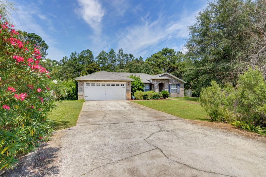 Welcome home to this updated all brick home located on a cul-de-sac in Navarre's popular neighborhood of Holley by the Sea featuring 3 bedrooms plus a flex room! You'll enjoy the privacy of being tucked back from the road on this half acre lot with a fully fenced in backyard. Walk inside and appreciate the open floor plan with a high cathedral ceiling, and lovely wood laminate flooring throughout the living room and master bedroom. Appreciate neutral paint and updated lighting and plumbing fixtures throughout. The large living room is open to the formal dining room space, as well as an eat in kitchen space. The kitchen features plenty of counter space with stainless appliances and a separate pantry, and tasteful backsplash among the wood cabinetry. Off of the living room you'll find the  fantastic heated and cooled bonus room with tiled floors and french doors leading to the extra large patio within a beautiful fenced in and irrigated yard. The owner's suite is a great size with a large walk in closet, and a bathroom featuring double vanities, and a separate shower and soaking tub. The other two bedrooms are located on the other side of the house and share a bathroom. The interior laundry room has additional storage and leads to the two car garage. Don't miss out on this exceptional home and enjoy being close to the beautiful white sand and emerald green water at Navarre beach, as well as enjoy fantastic amenities at Holley by the Sea's multi million dollar recreational facilities like pools, tennis, gym, boat launch, etc!
