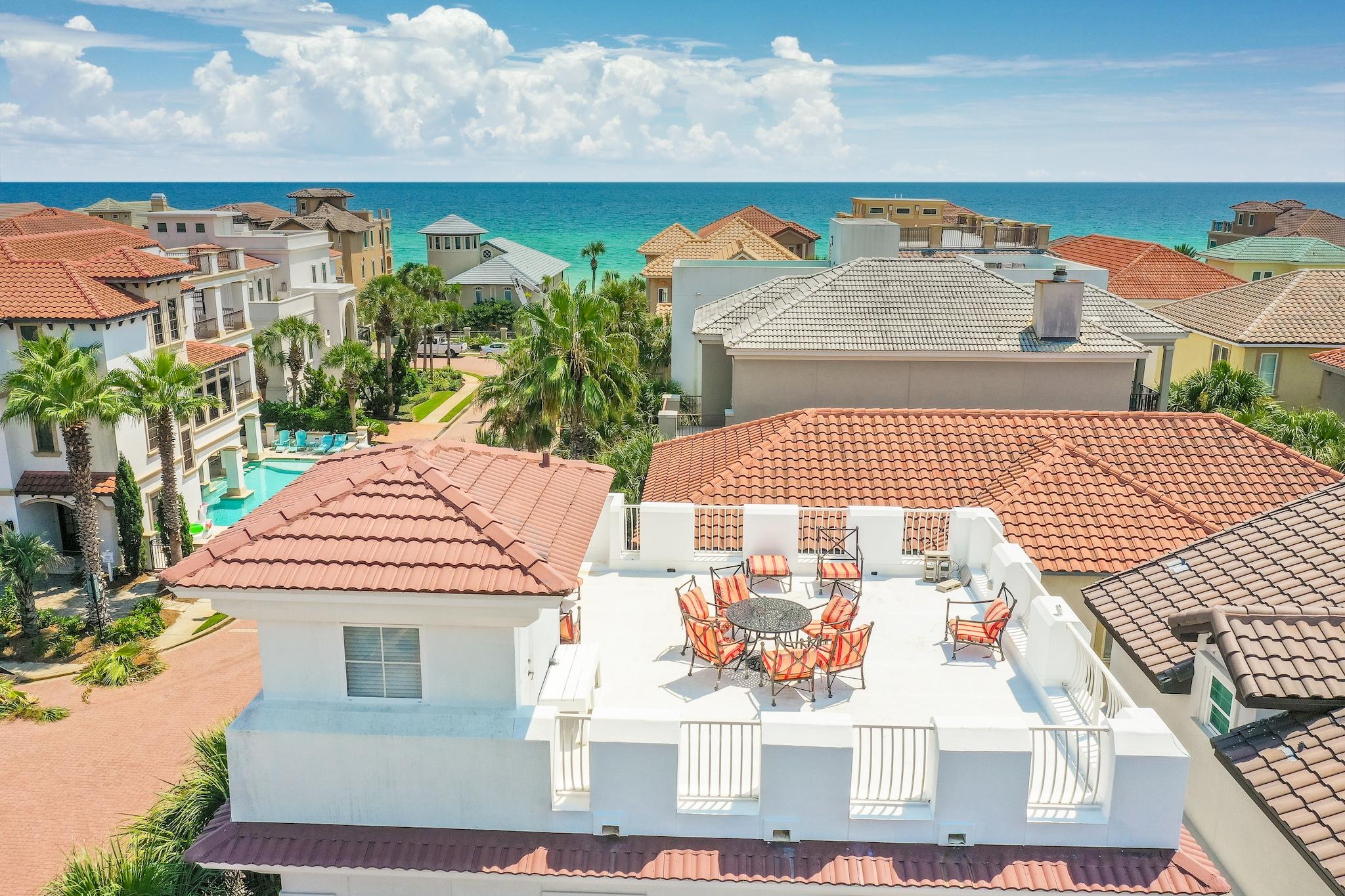 This incredible home in the gated community of  Destiny by the Sea is situated on a gracious corner lot approximately 250 feet from neighborhood beach access and 150 feet from the neighborhood pool. On the first floor is an enclosed garage as well as a guest bunk bedroom with full bath and walk in shower.  A gas fireplace welcomes you to the principal living areas located on the second floor. The long island breakfast bar in the kitchen invites conversation with the cook. Stainless steel appliances include a gas range, vent hood, refrigerator and dishwasher, which are complemented by overhead cabinets.  French doors in both the living and dining room areas lead to Juliet balconies. The living area features built-in surround sound. The elegant master bedroom is located on the third floor. It is adorned with a gas fireplace with inviting mantel. The master bath features a large walk in shower and double vanity. French doors lead from the master bedroom onto its very own balcony with Gulf views. An additional guest bedroom can also be found on the third floor. Its bath features a large walk in shower. Finally, a roof top deck gorgeous gulf views and is an ideal spot for entertaining. This truly amazing feature captures sunsets over the Gulf of Mexico. Destiny by the Sea features over 1,700 feet of private beachfront. This home is being sold fully furnished.