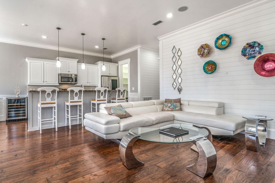 After undergoing a major renovation, 1942 Boardwalk is back on the market! Don't be fooled by this Mediterranean inspired home. The interior is a coastal farmhouse style that everyone is dying to own. Pull up to a large driveway and enter through the front door and be amazed as you see a hallway lined floor to ceiling with shiplap that leads to a beautiful open kitchen/living room/dining room. The shiplap continues through the living room and into to wainscoting around the dining room. Enjoy a meal at your custom kitchen table or beautiful bar stools. New appliances were installed during renovation and custom shelving in the pantry. There is a bedroom and a full handicap accessible bathroom downstairs. Walk up the stairs and find the master suite, an incredible bunk room and a 4th bedroom.