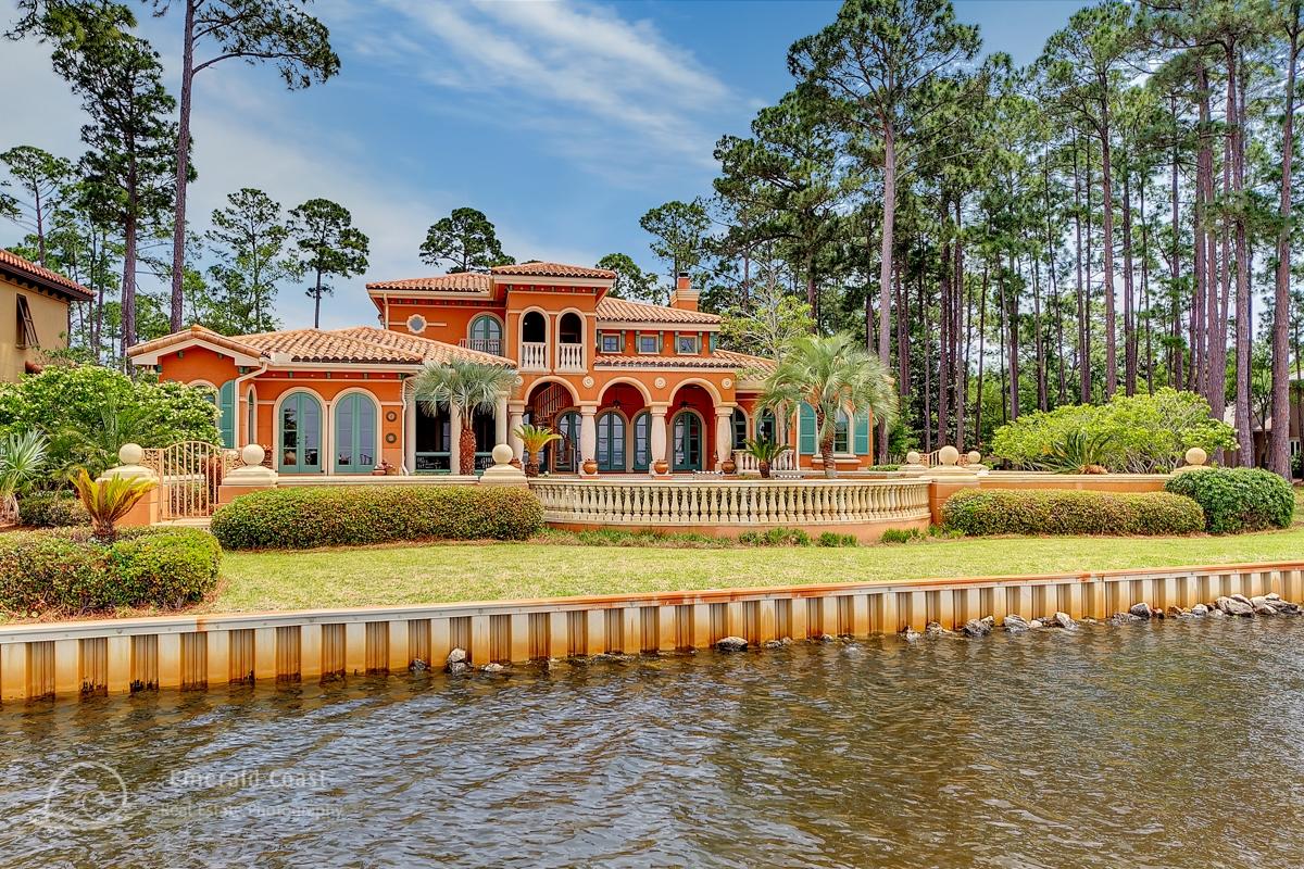 Perhaps the best location in Sandestin. A Tuscan estate perched aside the serene waters of the Choctawhatchee Bay, offering spectacular sunsets in the prestigious gated neighborhood of Burnt Pine. Ideal floor plan with voluminous formal entry including soaring two story ceilings, winding marble staircase, sun-lit living room and a gracious formal dining room. The oversized kitchen with breakfast area leads to both the game and media rooms through arched doors. It is accommodating to even the most discerning buyer who seeks to have an abundance of amenities, including private Trex dock with boat lift, 40 foot pool, oversized garage with separate boathouse bay and generous brick motor court.