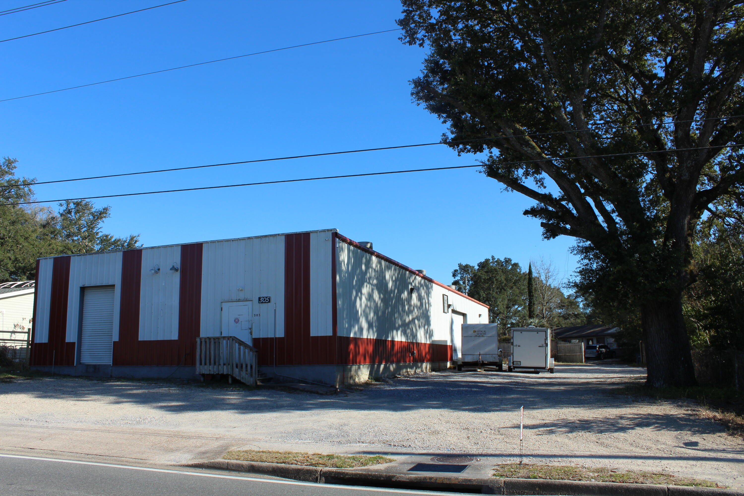 This great industrial lot and warehouse with 4576 sq ft is located centrally in Niceville, FL. The warehouse is approximately 45x105 feet and sits on a 0.30 acre lot. The office and storage space has two single and one double electric rollup doors and a loading area for small trucks. There is an office space and two restrooms as well as a mini split system to heat and cool the area. New fencing is currently being added to the lot. The property has 4,600 total square feet with parking space for about 12 cars on the front and side of the building. This is flood zone X so no flood insurance is required. Buyer to verify all dimensions and information.