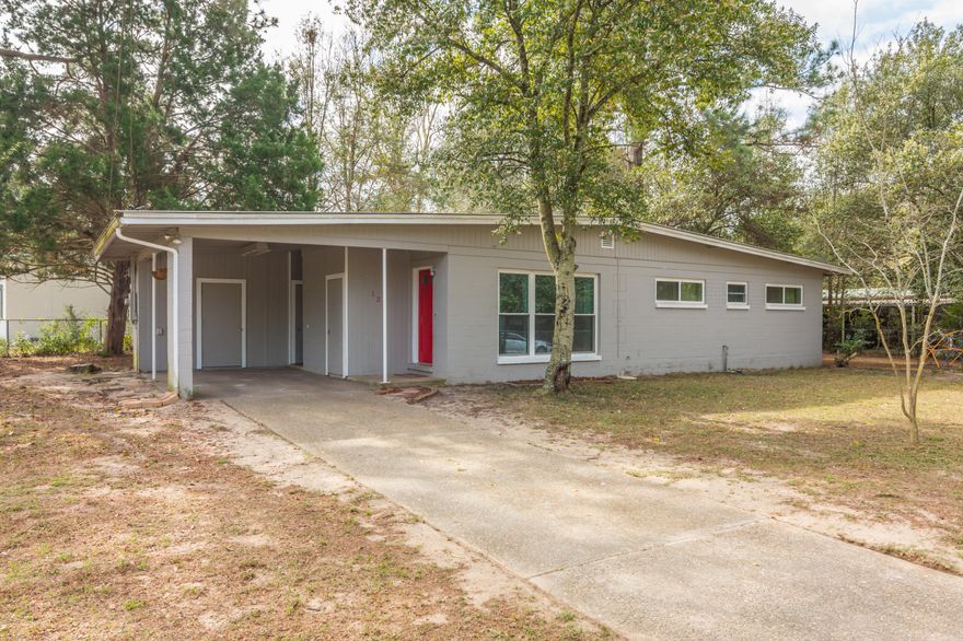 Move in ready! 3 bedroom 1.5 bath mid century modern home with upgrades throughout. Very large nice fenced corner lot starts the walk through of this nicely painted block home with a metal roof and a nice carport. Entering the home you will notice lots of natural light from the upgraded windows with hurricane shutters (done 3 years ago) lighting up the freshly painted interior of the living room. Living room window is impact proof. Carpet in living room and hallway is less than 2 years old. The kitchen has new vinyl floors and white cabinets to compliment the room. Lots of storage both inside and out with this one. Seller is giving a one year home warranty at no additional cost to the buyer. Definitely a must see and short drive to down town Crestview and Twin Hills Park.