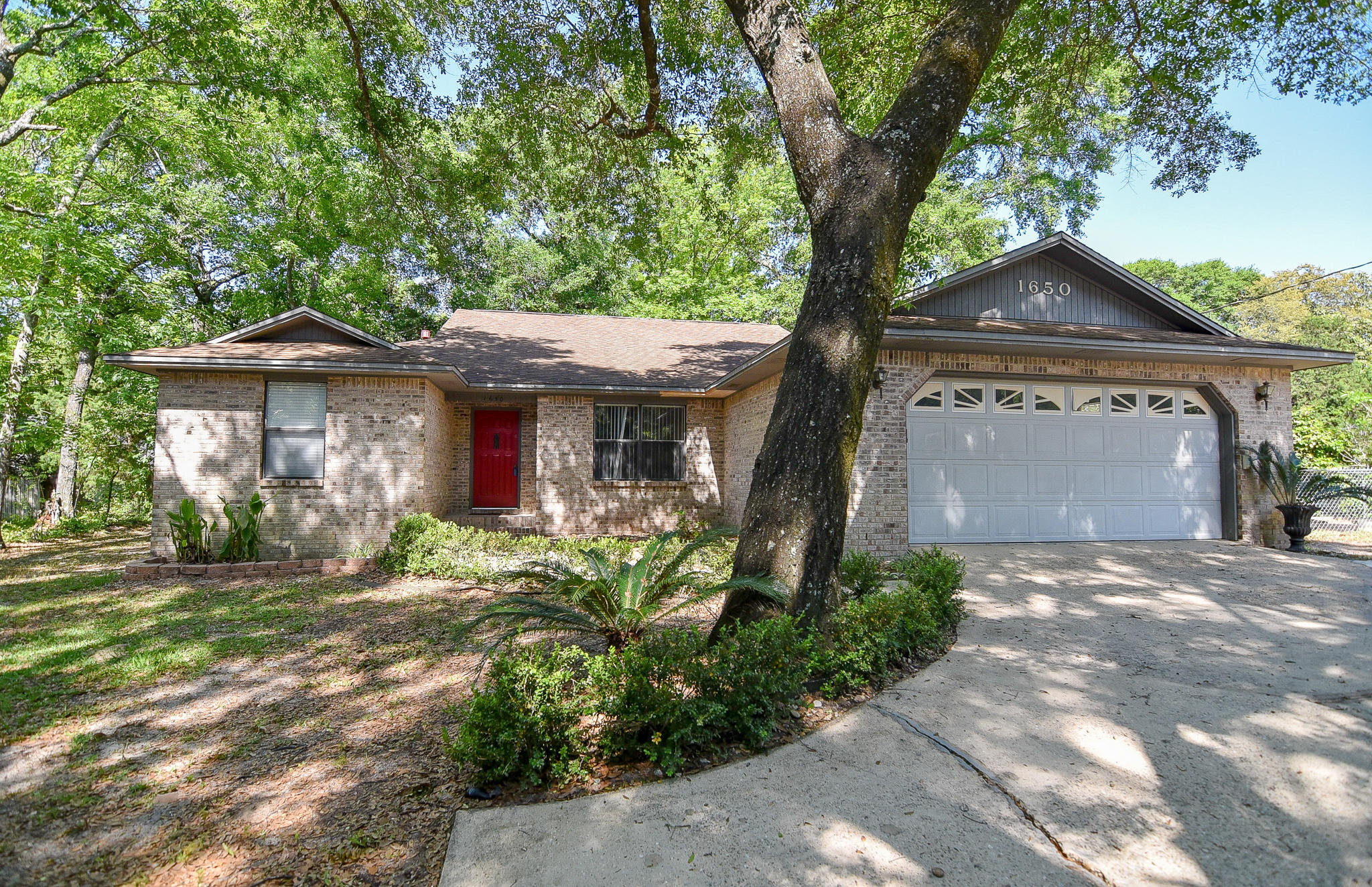 Welcome home to this 4 bedroom and 2 bathroom split floorplan home in the heart of Niceville on a .31 acre lot!! With 2,232 SF of living space, this home is spacious enough for everyone to spread out. The great room features a gas fireplace with raised brick hearth and skylights that provide natural lighting. A large eat-in kitchen features another walk-out to the back patio, and there's also a separate dining room for additional eating space. The master suite has a large walk-in closet and sliders leading to backyard. The master bath features dual vanities, a bathtub, and a separate shower. 3 additional bedrooms and 1 bathroom are located on the opposite side of the home. The Florida room with an oversized window is the perfect place for a playroom or even just to sit and read.