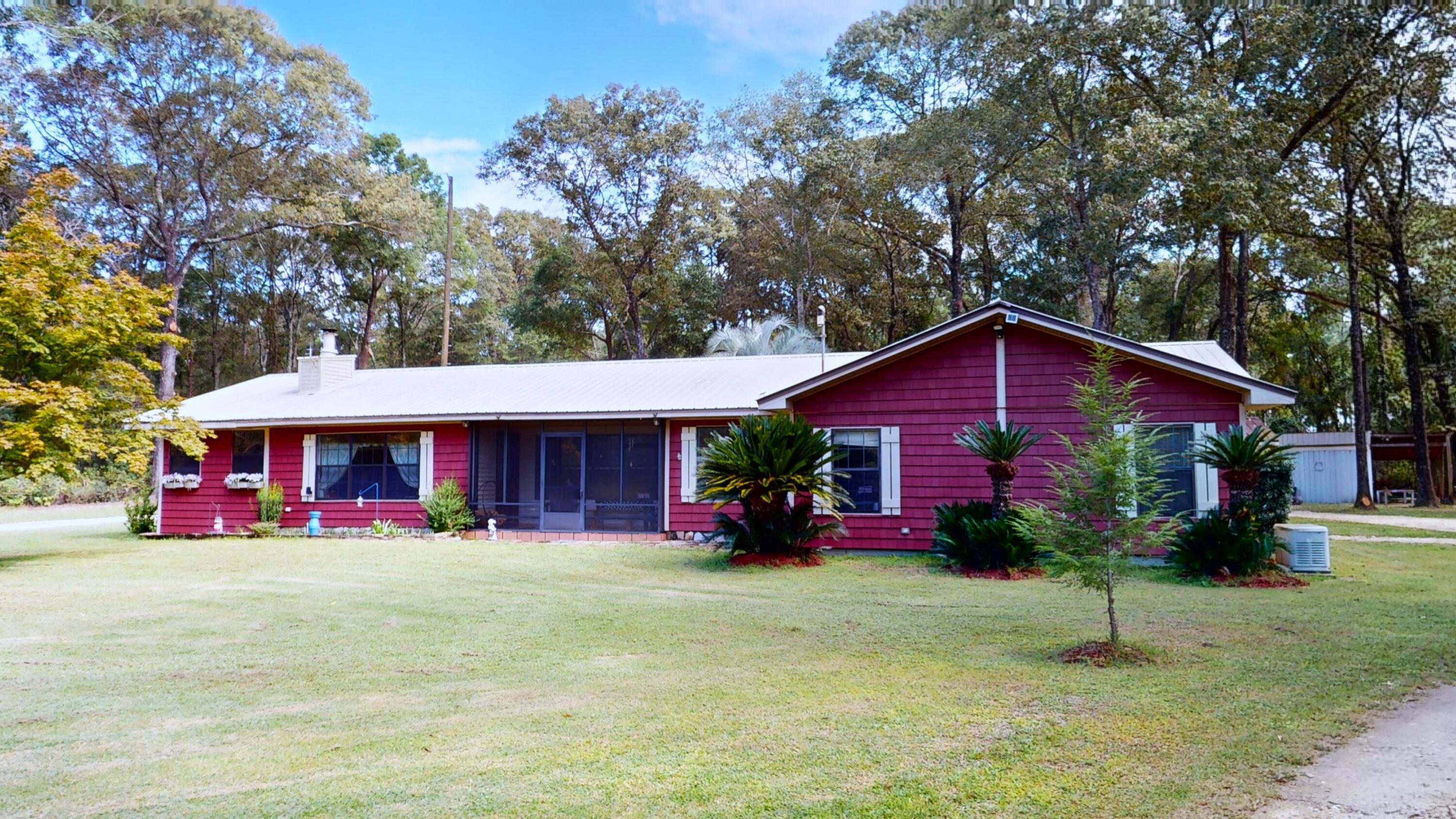 Country Home on 1.19+/- acres. Spacious, Five bedrooms, 2 baths and a den/office. Primary bedroom with oversized bathroom, with walk thru to the hot tub. Separate 14x24 Office with a half bath. 2 A/C units (1 unit 22 SER) and 3 ton generator K22 that runs off propane tank. Metal roof with lifetime warranty - all screws were changed out in 2023. 2 separate breakers in houseOutside features: pole barn 32x60 with heated/cooled office toilet & overhead storage; small shed; and 60x25 shed, barn for truck and boat shed.  All power is unground. Deep well. Drain fill 1 yr old and septic pumped 2023. Don't miss this one!