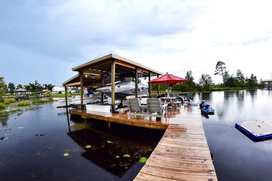 Over 1.3 acres of waterfront bliss!! This 4BR/2BA home on Deerpoint Lake is ready to go for boat and water lovers! The 38' boat house has a 12,000lb lift which can accommodate up to a 25' boat and a 5500lb lift ideal for a pontoon boat! This home is all set up for entertaining with a summer kitchen to die for with granite counters and rust-resistant grills and cookers, all covered with a sail shade! There is another sail shade over the patio where you can enjoy amazing sunsets over the lake! Additional outdoor amenities include a gazebo and a 22x36 workshop/garage with 125 amp service and roll-up doors. Perfect man cave! The interior of the home boasts quality craftsmanship and impeccable details such as step down crown molding, french doors, bay windows, hardwood and tile flooring, and  a split-bedroom floor plan. The Kitchen has Corian countertops, stainless steel appliances and a separate pantry and breakfast nook. The Master Suite overlooks the backyard and water and the adjacent bath features a double sink vanity, whirlpool tub, separate shower and a huge walk-in closet. So much more we could mention, but this home is truly a must-see!
Water lovers will LOVE this home! All information approx and must be verified by buyers if important.