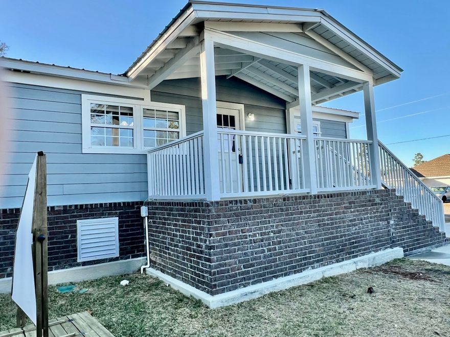 Welcome home to this beautifully remodeled 3 bedroom, 2.5 bath home situated on 1/3 of an acre with no HOA! Completely updated in 2022, this home boasts charming brick skirting, durable hardy board siding, and a metal roof.  The spacious front and side covered porches provide the perfect spots to relax and enjoy the outdoors, while the large yard offers plenty of space for play or entertaining.  Inside, you'll love the open-concept family room and kitchen, ideal for gatherings.  The kitchen features stunning cabinetry and ample counter space.  The home includes a guest bedroom, an additional bedroom with a half bath, and a large master suite with a walk-in closet and an updated en-suite bathroom.  Laminate flooring throughout.  Buyer to verify all information and dimensions.