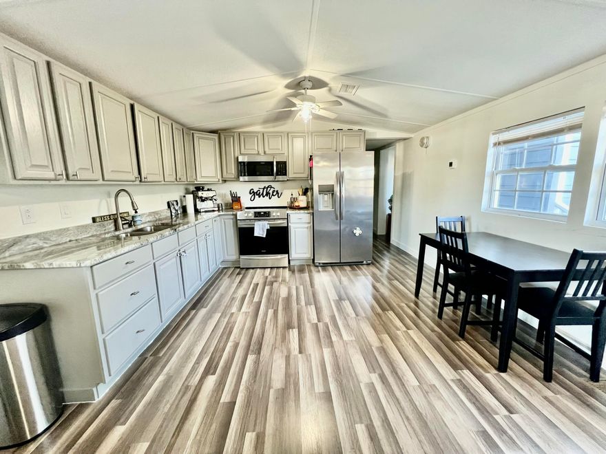 Welcome home to this beautifully remodeled 3 bedroom, 2.5 bath home situated on 1/3 of an acre with no HOA! Completely updated in 2022, this home boasts charming brick skirting, durable hardy board siding, and a metal roof.  The spacious front and side covered porches provide the perfect spots to relax and enjoy the outdoors, while the large yard offers plenty of space for play or entertaining.  Inside, you'll love the open-concept family room and kitchen, ideal for gatherings.  The kitchen features stunning cabinetry and ample counter space.  The home includes a guest bedroom, an additional bedroom with a half bath, and a large master suite with a walk-in closet and an updated en-suite bathroom.  Laminate flooring throughout.  Buyer to verify all information and dimensions.