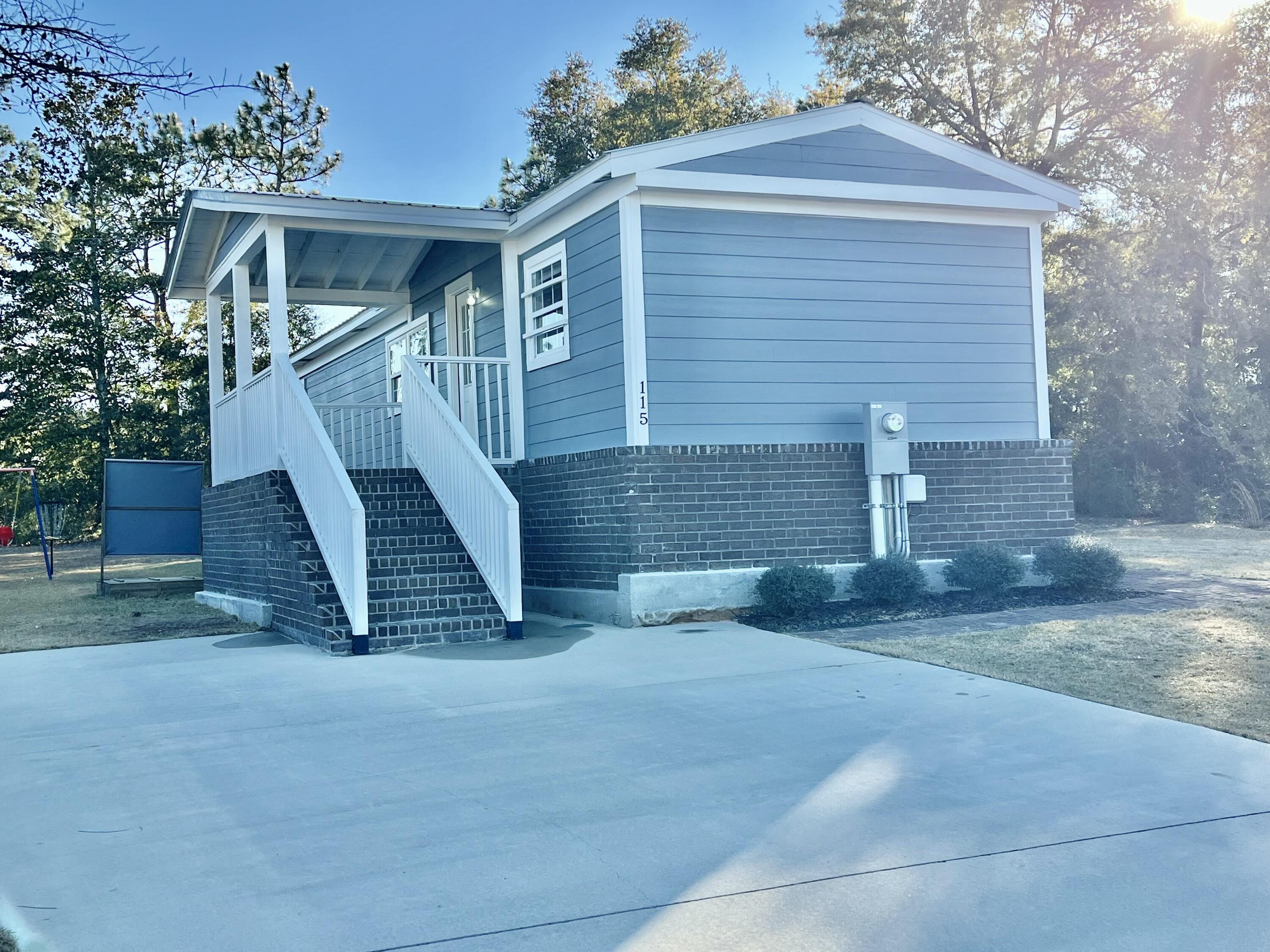 Welcome home to this beautifully remodeled 3 bedroom, 2.5 bath home situated on 1/3 of an acre with no HOA! Completely updated in 2022, this home boasts charming brick skirting, durable hardy board siding, and a metal roof. The spacious front and side covered porches provide the perfect spots to relax and enjoy the outdoors, while the large yard offers plenty of space for play or entertaining. Inside, you'll love the open-concept family room and kitchen, ideal for gatherings. The kitchen features stunning cabinetry and ample counter space. The home includes a guest bedroom, an additional bedroom with a half bath, and a large master suite with a walk-in closet and an updated en-suite bathroom. Laminate flooring throughout. Buyer to verify all information and dimensions.