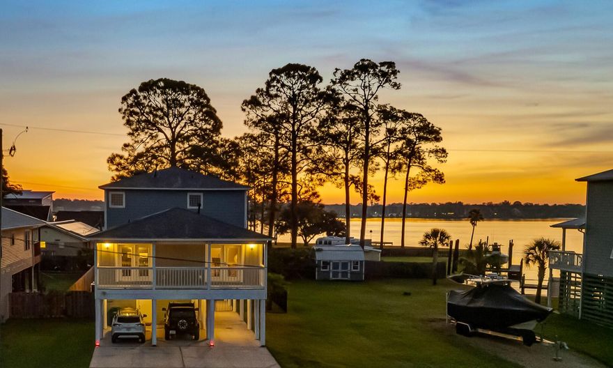 Water front view, without the water front price! Welcome to your new home, where sweeping bayou water views set the stage for everyday living. This home captures the charm of coastal living with tranquil 180 degree bayou vistas right from your porch. The natural lighting is sure to impress.  Two large porches and inviting living spaces create a seamless connection between indoors and out. Step onto the main floor porch to take in the peaceful setting, perfect for morning coffee or evening gatherings, or take a nap in your hammock off the master bedroom porch after a long week.  The large kitchen with an expansive island opens to the dining and living area. Whether you're entertaining or simply enjoying the view,  this property offers a rare opportunity to experience the beauty of bayou-front living in the heart of NicevilleThe under-house parking provides flexible use and can easily be enclosed for added storage, a home gym, or a versatile workspace.