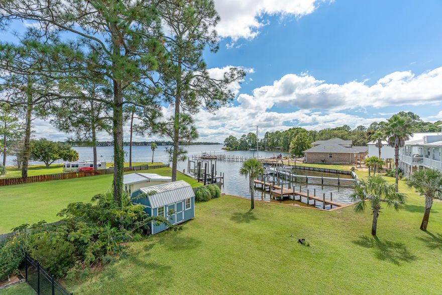 Water front view, without the water front price! Welcome to your new home, where sweeping bayou water views set the stage for everyday living. This home captures the charm of coastal living with tranquil 180 degree bayou vistas right from your porch. The natural lighting is sure to impress.  Two large porches and inviting living spaces create a seamless connection between indoors and out. Step onto the main floor porch to take in the peaceful setting, perfect for morning coffee or evening gatherings, or take a nap in your hammock off the master bedroom porch after a long week.  The large kitchen with an expansive island opens to the dining and living area. Whether you're entertaining or simply enjoying the view,  this property offers a rare opportunity to experience the beauty of bayou-front living in the heart of NicevilleThe under-house parking provides flexible use and can easily be enclosed for added storage, a home gym, or a versatile workspace.