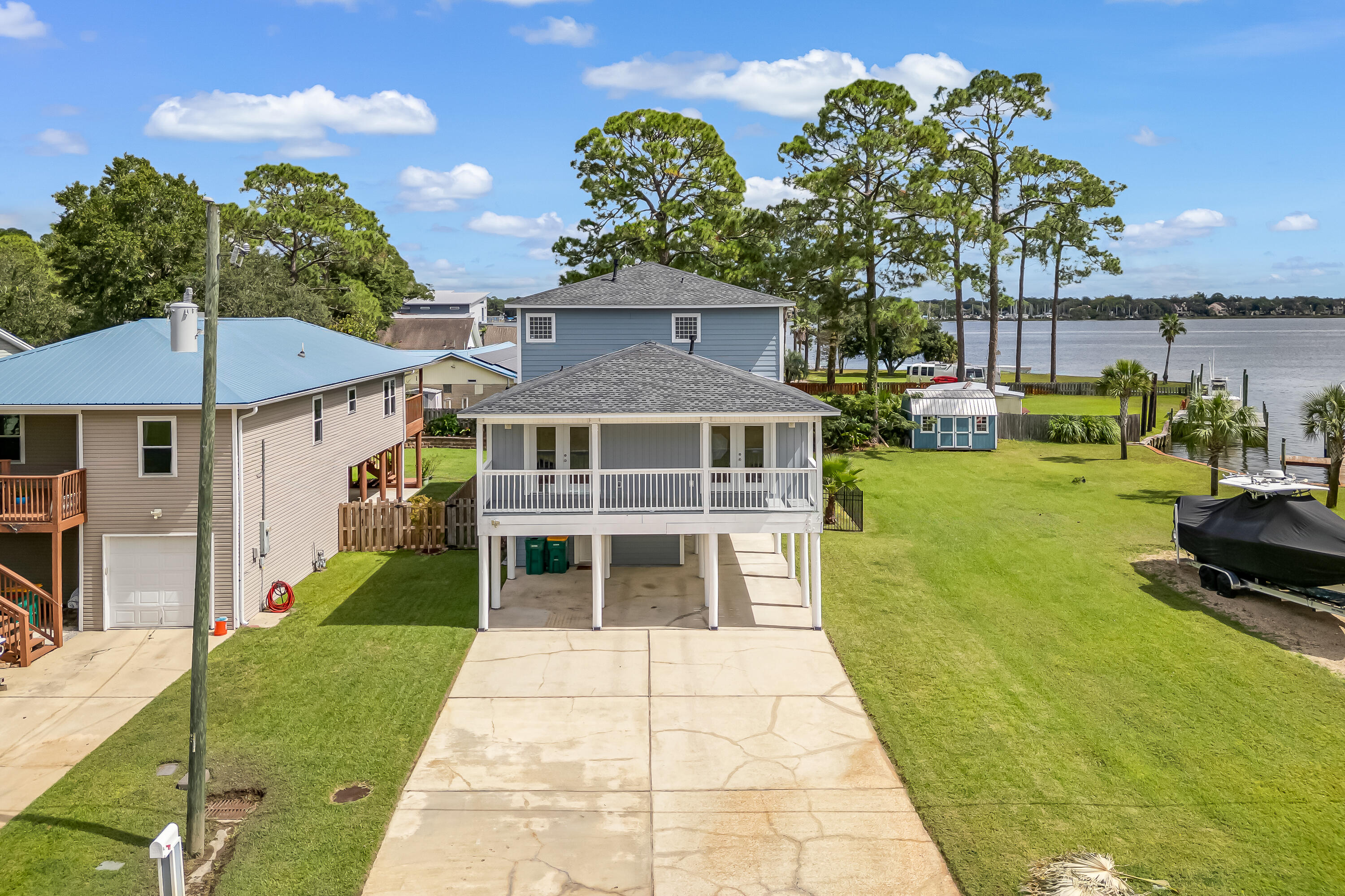 Welcome to your new home, where sweeping bayou water views set the stage for everyday living. This home captures the charm of coastal living with tranquil 180 degree bayou vistas right from your porch. The natural lighting is sure to impress. Two large porches and inviting living spaces create a seamless connection between indoors and out. Step onto the main floor porch to take in the peaceful setting, perfect for morning coffee or evening gatherings, or take a nap in your hammock off the master bedroom porch after a long week. The large kitchen with an expansive island opens to the dining and living area. Whether you're entertaining or simply enjoying the view, this property offers a rare opportunity to experience the beauty of bayou-front living in the heart of Niceville. The under-house parking provides flexible use and can easily be enclosed for added storage, a home gym, or a versatile workspace.