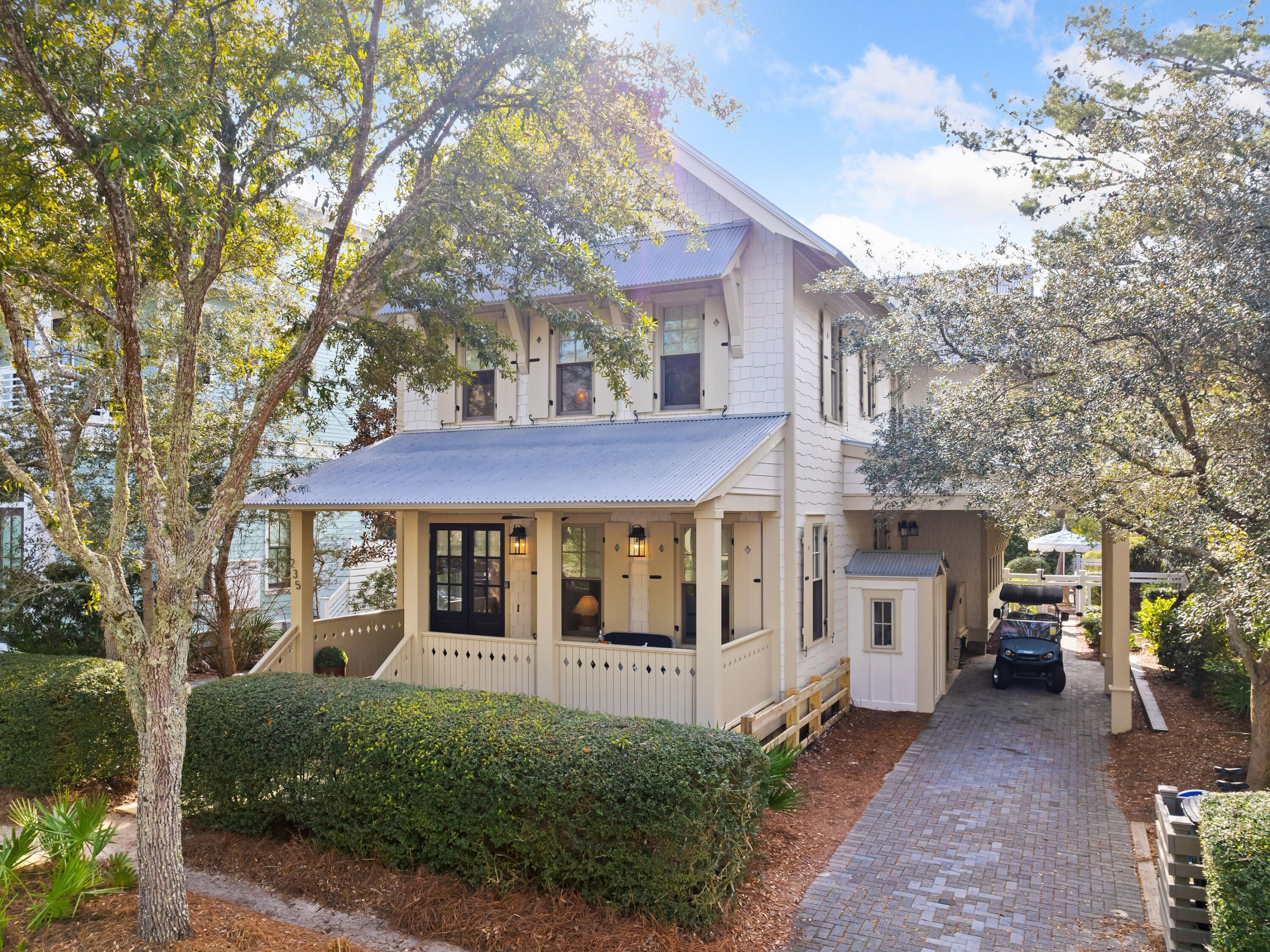 Sophisticated charm and private indulgence define the coastal palette of this bright and beautiful beach cottage nestled on the quietest of streets in the heart of WaterColor's highly-coveted Phase III. With more than 2,500 square feet of living space, this four-bedroom, four-bath coastal retreat overlooks a nature preserve and affords owners ultimate privacy and serenity with an effortless walk over the bridge to the town center and beaches of WaterColor. The stunning interior of this upscale beach cottage is thoughtfully curated with exceptional finishes from Serena & Lily, Cailini Coastal, and Beau Interiors including original artworks, vintage collectibles, one-of-a-kind antique selections, gorgeous custom rugs, and even a new custom-built back porch swing.