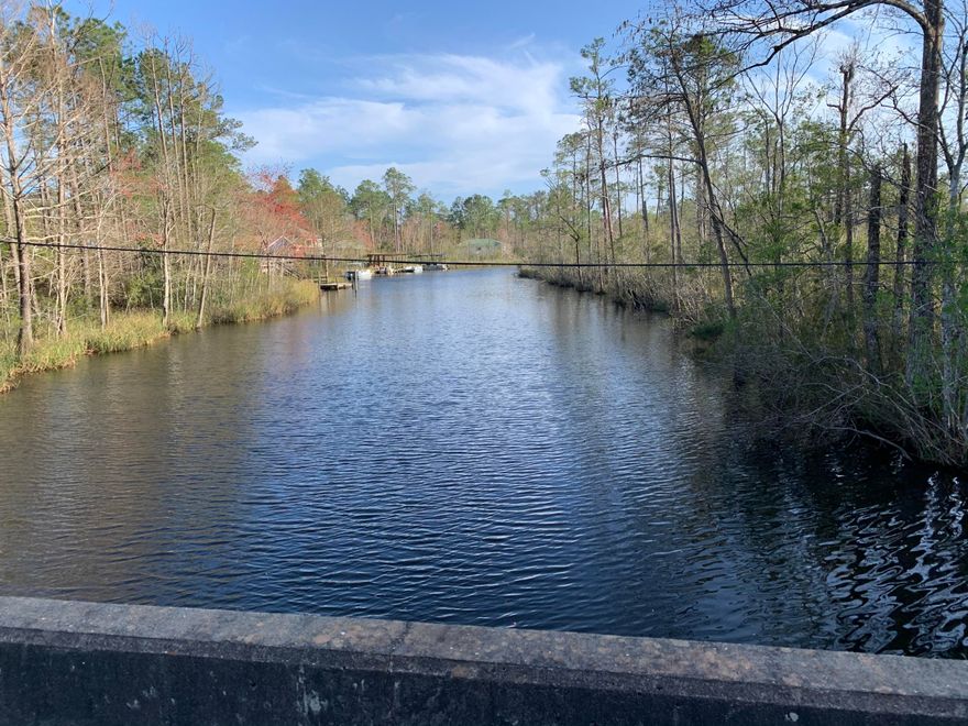 Lot is on the Alaqua Slough. Water is 2-3 feet deep.