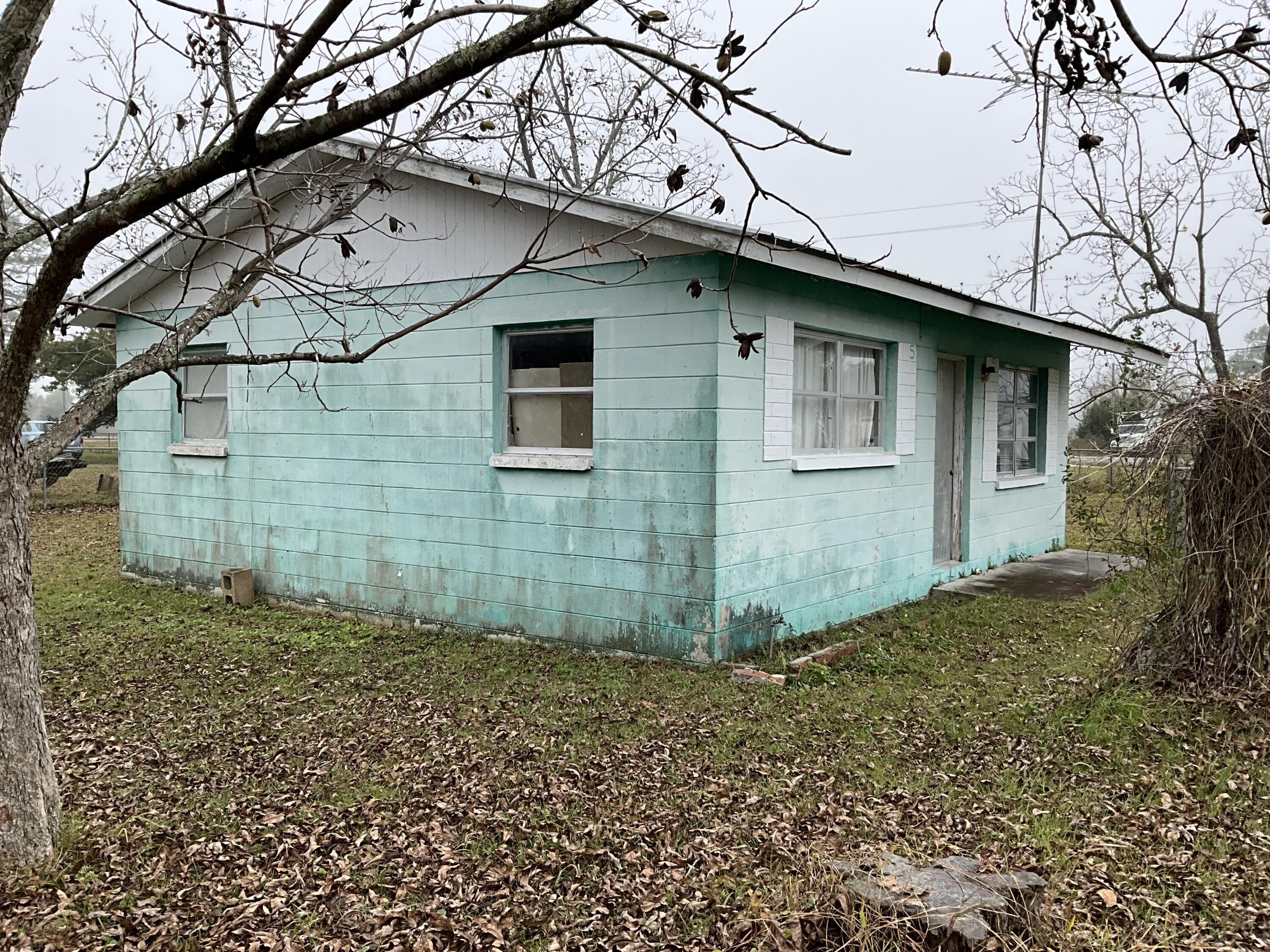 Fantastic Opportunity to own a little piece of Apalachicola History. The 2 bedroom/1 bathroom beach cottage sits on a .53 acre parcel with an additional mobile home on the back of the lot, Mixed use opportunities! The 2/1 home has a metal roof and both dwellings would be great to fix up and use as  summer getaways or vacation rentals. Situated on a large corner lot with pecan and pear trees and bay views. What are you waiting for! A property such as this one has so much offer and do not come on the market very often. The possibilities are endless! Call today