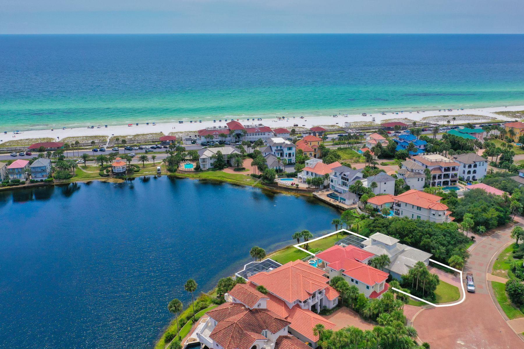 Modern elegance meets artful coastal contemporary design in this beautiful lake front retreat located within the gated beachside neighborhood of Destiny and perfectly situated on a coveted south facing homesite yielding direct gulf views. This home has been recently remodeled and refreshed offering notable features including a private screened resort-style pool area as well as three full bedroom suites and a third floor loft space that could be utilized as an office or fourth bedroom. This home is characterized by an impressive open floorplan offering two bedroom suites on the first floor as well as an expansive living room complete with pecky cypress ceilings, built-in gas fireplace with stone surround and ample windows yielding gorgeous gulf and lake views.