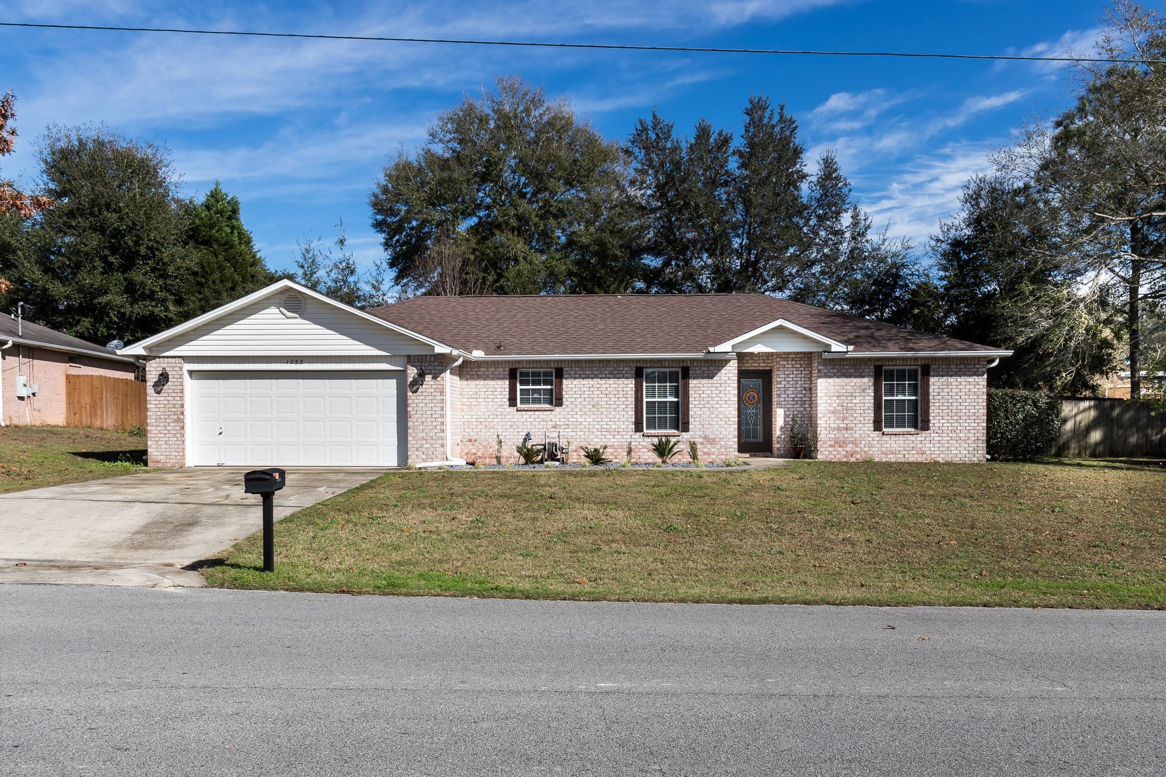 Wonderful South Crestview location! 10 minutes to 7th Special Forces Group, 20 minutes to Eglin AFB. **Brand new roof installed in 2018** Beautiful wood laminate flooring in all living spaces and bedrooms. Neutral gray tones throughout, including a kitchen that is sure to wow! Painted cabinets, fresh subway tile backsplash, and granite countertops complete this kitchen refresh--making it on trend and functional for even the most discerning homeowner. Foyer features wainscoting entrance and Nest thermostat. Laundry room is massive, with additional folding/storage area. The 3 bedrooms are all generous in size, with great closet space. Master bedroom/bathroom area features 2 walk in closets, new double vanity. Backyard is a large .28acres and extends beyond privacy fence (see survey).