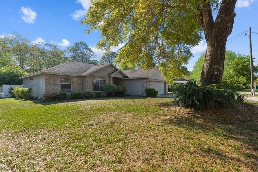 This lovely one owner home is centrally located in the heart of Niceville! Well-maintained, this home features hardwood and tile flooring throughout. A split floor plan with the Master overlooking the beautiful covered deck and spacious backyard. The large master closet has custom built-in shelving and the master bath is a great place to unwind! The kitchen features stainless steel appliances and great views of the fenced in back yard. This home has a gas fireplace, stove/oven, furnace, and water heater. The 23'x15' workshop has power and a place to park your toys! Less than a 5 minute walk from the beautiful views of the Choctawhatchee Bay!