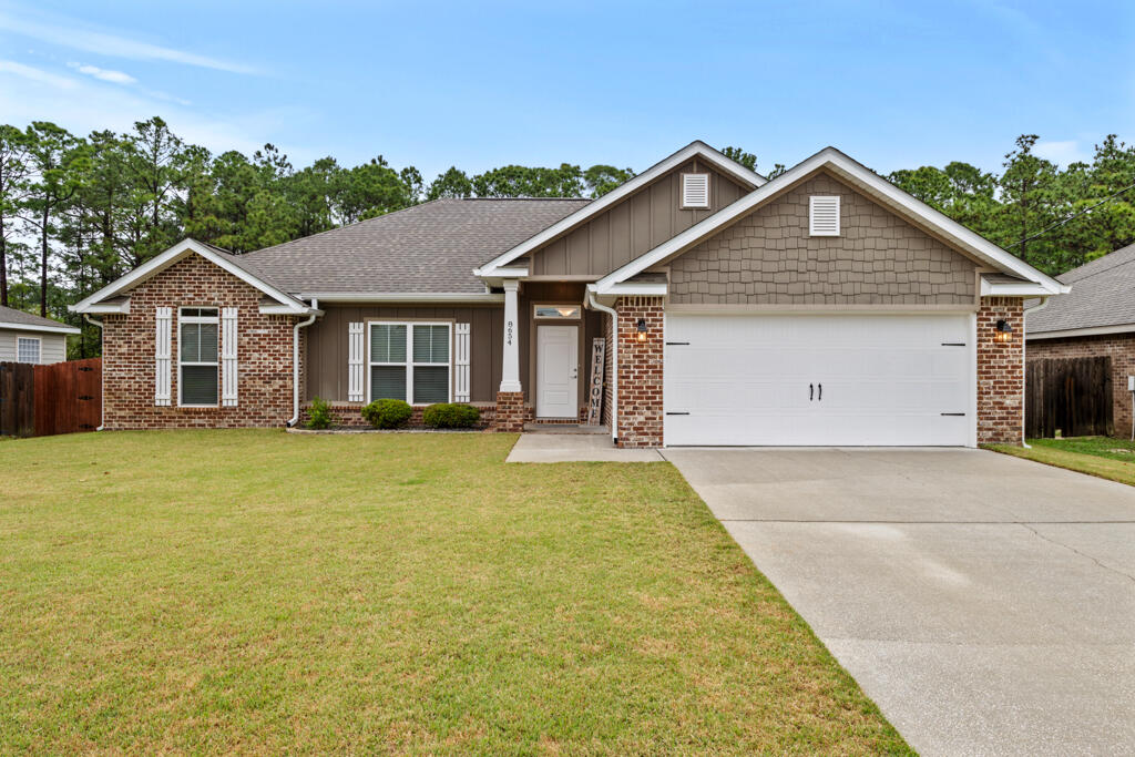 ** Assumable 4.125% VA Loan for qualified buyers!! ** Welcome to this beautiful newer construction brick home offering a spacious and functional split floor plan with 4 bedrooms and 2 bathrooms. Located just 2 miles from the Navarre Beach Pier, 10 miles to Hurlburt Field AFB, a short drive to grocery stores and restaurants, and easy commute to Hwy98, FL-87 and I-10. Situated on a generous third-of-an-acre lot with no HOA, this home provides plenty of room to enjoy outdoor living, with the lot line extending past the current fence and a utility easement ensuring nothing will be built directly behind you, offering added privacy. Step inside to discover a host of stunning updates that truly set this home apart. , The kitchen is a chef's dream with new appliances, double walk-in pantries, a professionally installed backsplash, granite countertops, island, breakfast bar, and plenty of counter and cabinet space. Just off the kitchen is the dining area that has sweeping views of the backyard and a door to the wrap-around covered patio. The primary bedroom features a lighted tray ceiling and a professionally renovated ensuite that boasts a STUNNING tiled walk-in shower, new mirrors, lighting fixtures, and a walk-in closet that has a separate door that is a direct entry into the laundry room for added convenience. Fresh interior paint throughout creates a bright and airy atmosphere, with new flush-mount recessed lighting to enhance that feeling. The spacious living room features a lighted tray ceiling and a large double hung window to let in natural light. The 3 additional bedrooms and updated guest bath are located just off the living space down a hallway. The exterior has been just as carefully upgraded, including 6" whole-house gutters to ensure protection from rain runoff, zoysia palisade sod with built-in sprinkler system that runs off underground well water, freshly stained privacy fence, and fresh exterior paint that boosts the overall charm of the home. With a 2-car garage, this home truly has it all, combining comfort, style, and thoughtful updates in an unbeatable location.