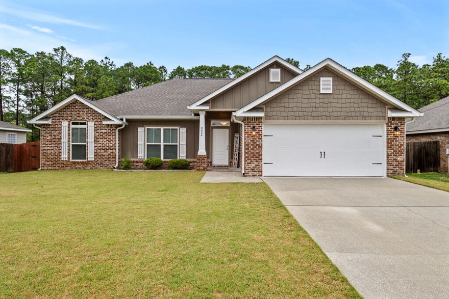 ** Assumable 4.125% VA Loan for qualified buyers!! ** Welcome to this beautiful newer construction brick home offering a spacious and functional split floor plan with 4 bedrooms and 2 bathrooms. Located just 2 miles from the Navarre Beach Pier, 10 miles to Hurlburt Field AFB, a short drive to grocery stores and restaurants, and easy commute to Hwy98, FL-87 and I-10. Situated on a generous third-of-an-acre lot with no HOA, this home provides plenty of room to enjoy outdoor living, with the lot line extending past the current fence and a utility easement ensuring nothing will be built directly behind you, offering added privacy. Step inside to discover a host of stunning updates that truly set this home apart. , The kitchen is a chef's dream with new appliances, double walk-in pantries, a professionally installed backsplash, granite countertops, island, breakfast bar, and plenty of counter and cabinet space. Just off the kitchen is the dining area that has sweeping views of the backyard and a door to the wrap-around covered patio. The primary bedroom features a lighted tray ceiling and a professionally renovated ensuite that boasts a STUNNING tiled walk-in shower, new mirrors, lighting fixtures, and a walk-in closet that has a separate door that is a direct entry into the laundry room for added convenience. Fresh interior paint throughout creates a bright and airy atmosphere, with new flush-mount recessed lighting to enhance that feeling. The spacious living room features a lighted tray ceiling and a large double hung window to let in natural light. The 3 additional bedrooms and updated guest bath are located just off the living space down a hallway. The exterior has been just as carefully upgraded, including 6" whole-house gutters to ensure protection from rain runoff, zoysia palisade sod with built-in sprinkler system that runs off underground well water, freshly stained privacy fence, and fresh exterior paint that boosts the overall charm of the home. With a 2-car garage, this home truly has it all, combining comfort, style, and thoughtful updates in an unbeatable location.
