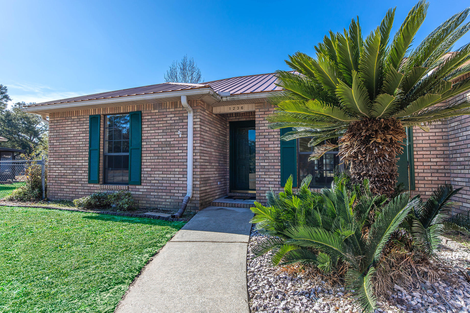 GORGEOUS and REMODELED! Amazing updates throughout this home which features 3 bedrooms, 2 full bathrooms and additional square footage added to its original floor plan. The Florida room gives this home an extra 287 sq.ft of heated and cooled space not included in sq footage. The home is all brick and has a metal roof. The inside and outside HVAC unit was replaced in the last year. If you have allergies or pets then you'll love the new porcelain wood looking tile throughout the home. New sinks, high 17 in. toilets, new granite countertops throughout, new ceiling fans, light fixtures, hardware, mirrors and so much more!! The workshop conveys as-is and has a 220 power, water and sewer for an RV. This home sits on a corner lot .41 of an acre. Roof 2013, HVAC 2020.